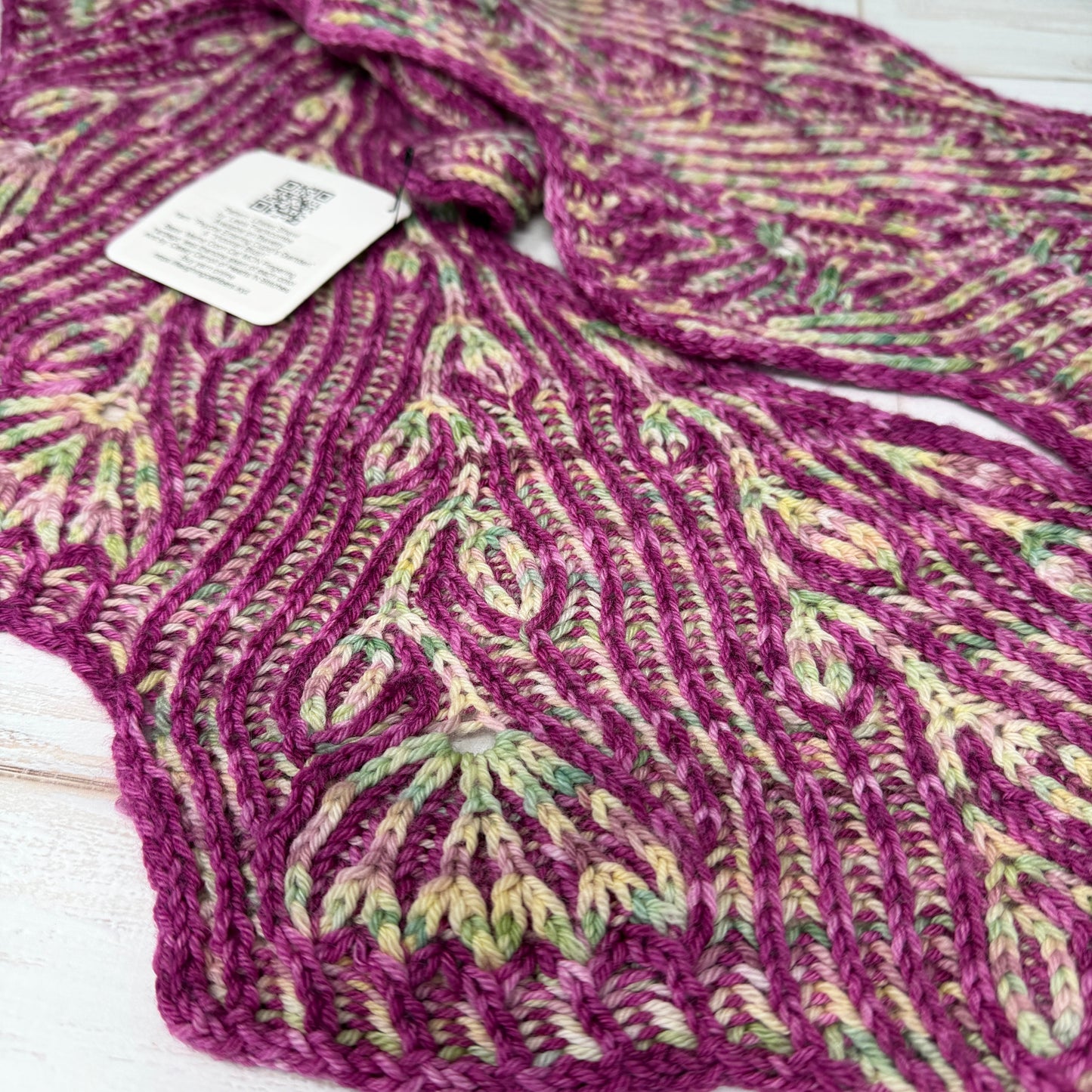 Purple patterned garment with a tag on a white background