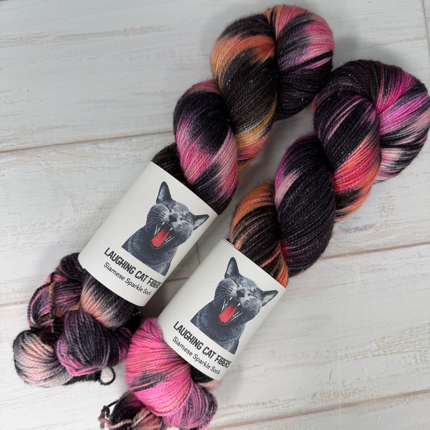 “Closeup of two skeins of The Poet X yarn displaying texture, saturation, and rich overdyed black color layering.”