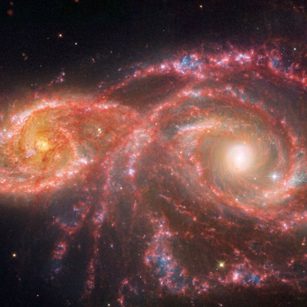 Two spiral galaxies interacting in space