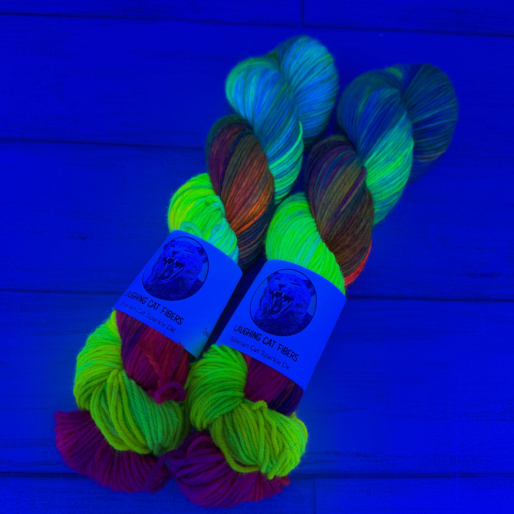 Multicolored skeins of yarn with labels in black light