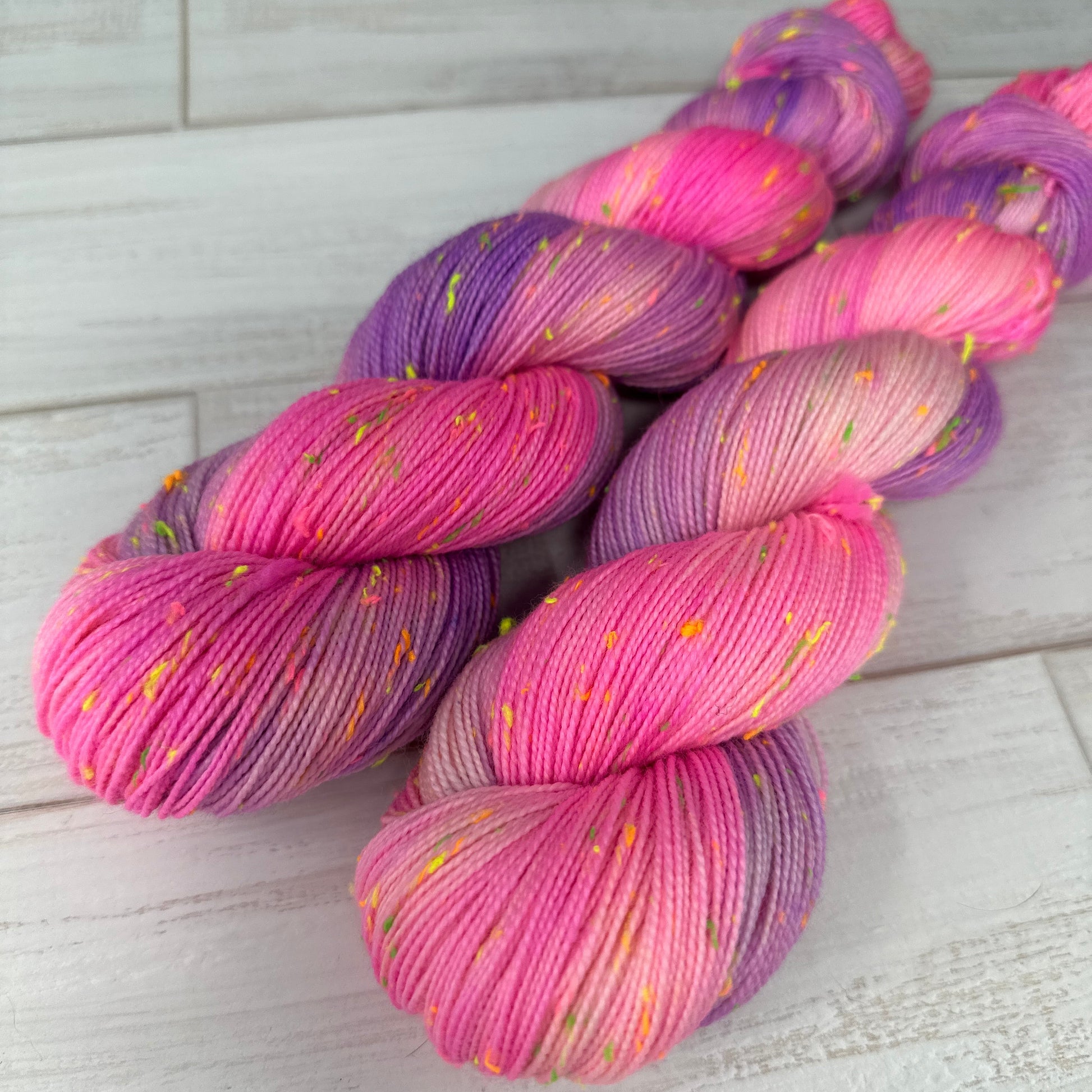 “Hand dyed pink and purple yarn with neon Donegal neps on ToyBob Sock base.”