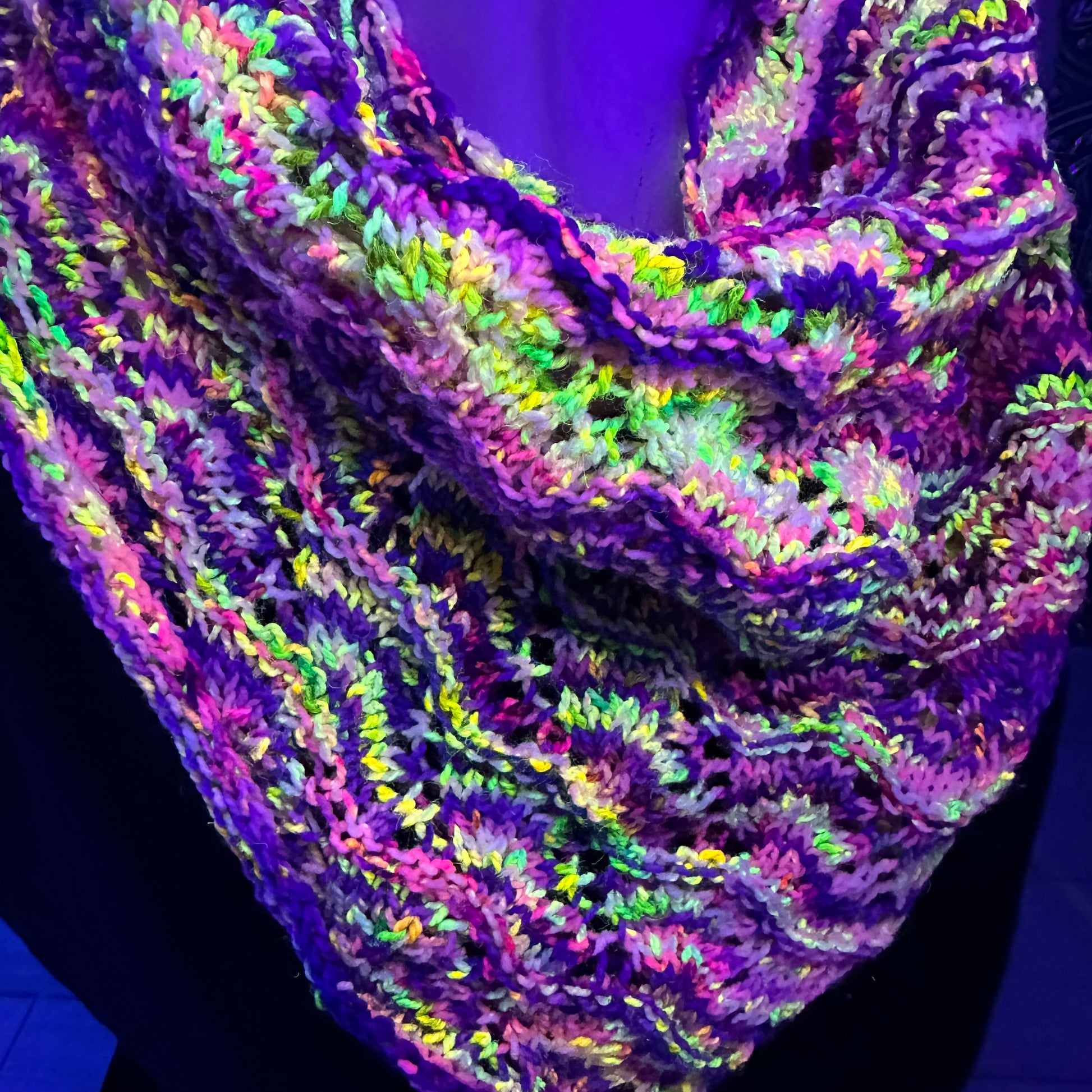 Multicolored knitted scarf on a dark background