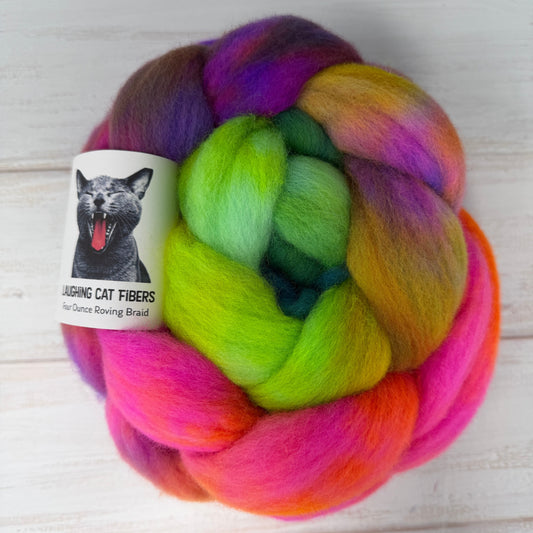 Multicolored skein of yarn with a label on a light wooden surface