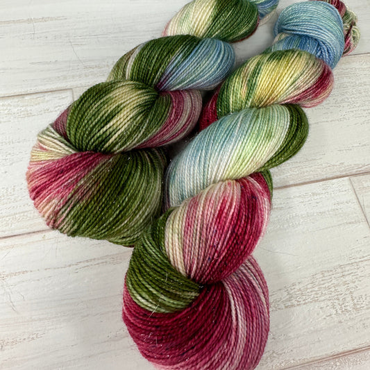 Multicolored skein of yarn on a light wooden surface