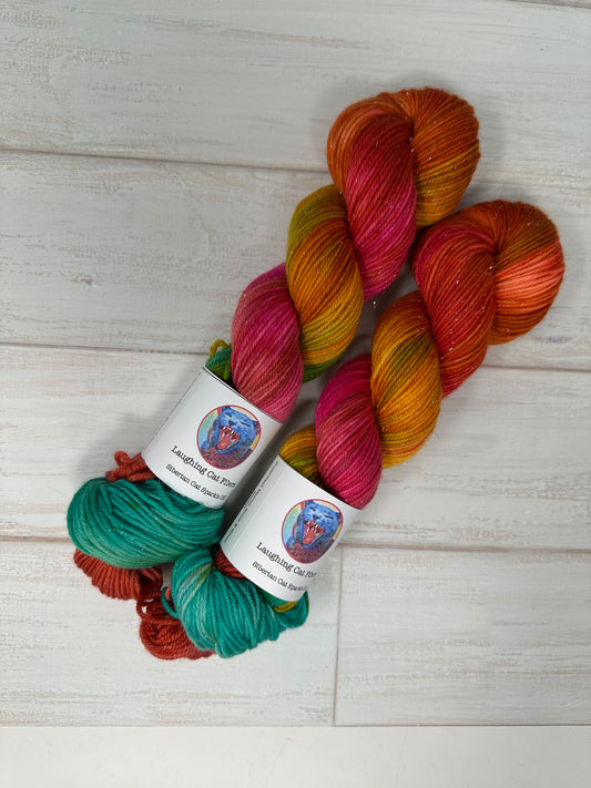 Colorful skeins of yarn with labels on a light wooden surface