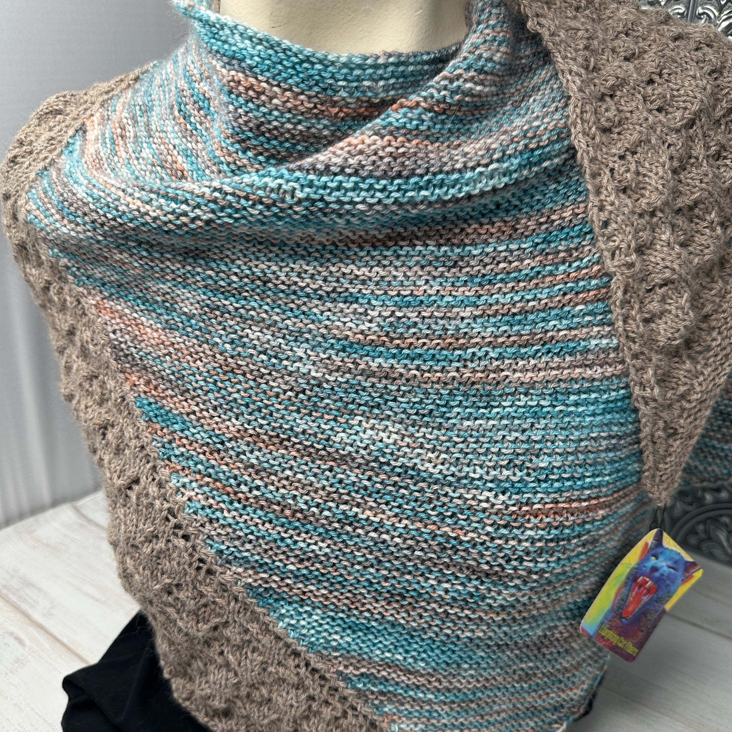 Knitted blanket with a pattern on a wooden surface