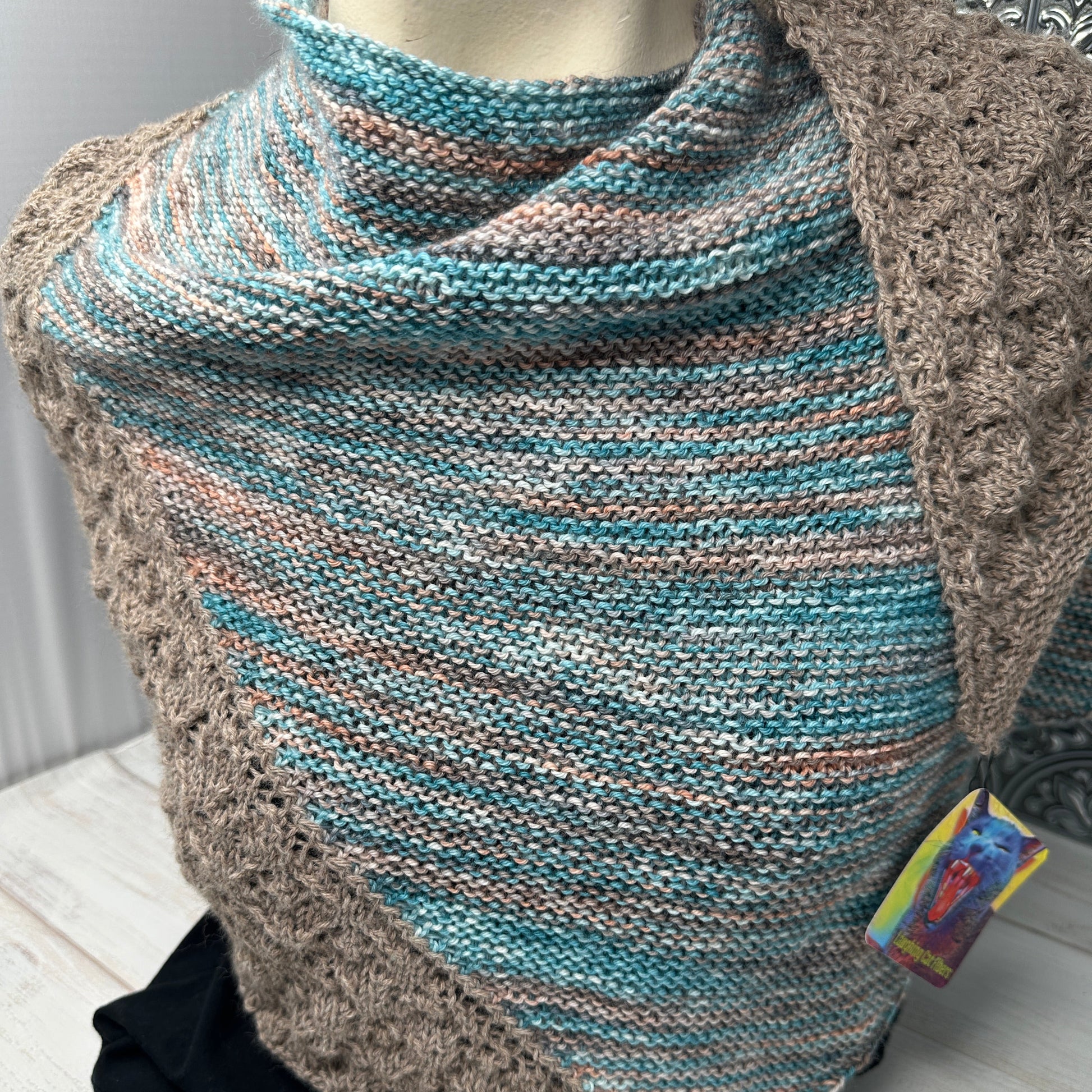 Knitted blanket with a pattern on a wooden surface