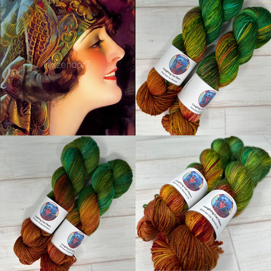 Yarn skeins with labels on a wooden surface, featuring a vintage-style portrait of a woman.