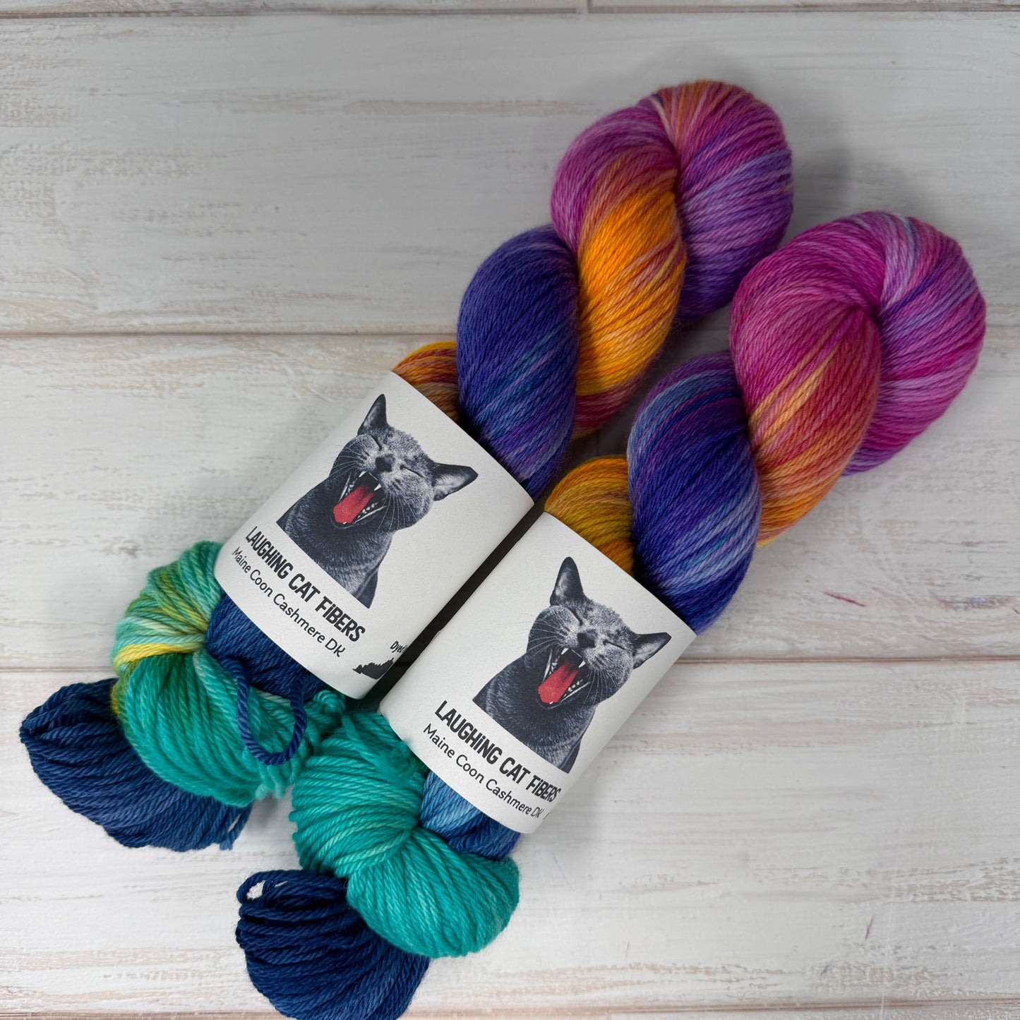 Colorful skeins of yarn with labels on a wooden surface