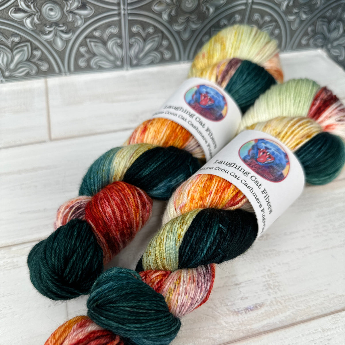 two skeins of MCN fingering hand dyed by Laughing Cat Fibers in their Spring colorway 