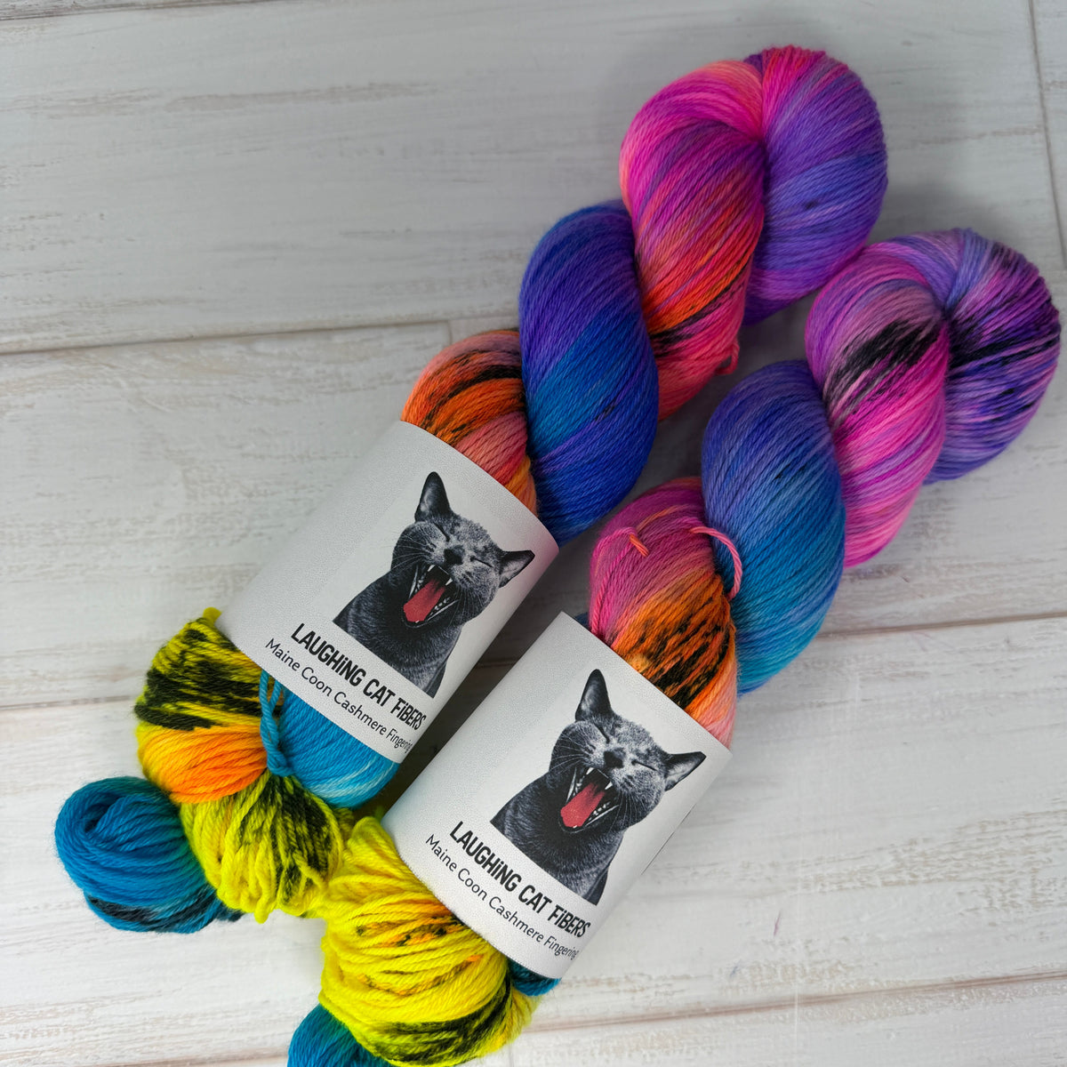 Colorful skein of yarn with labels on a light wooden surface