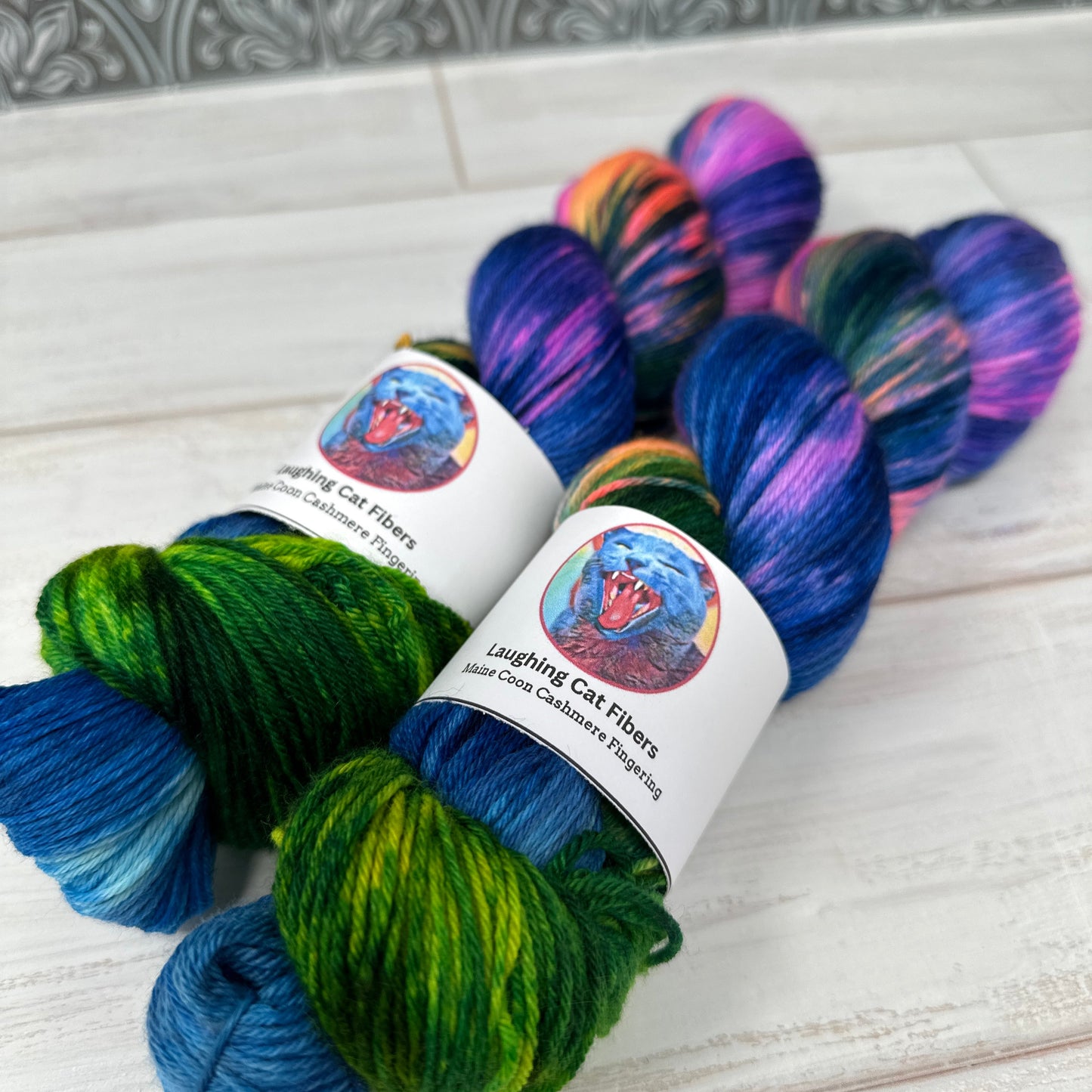 two skeins of MCN fingering hand dyed yarn by Laughing Cat Fibers in their Cartwheel Galaxy colorway 