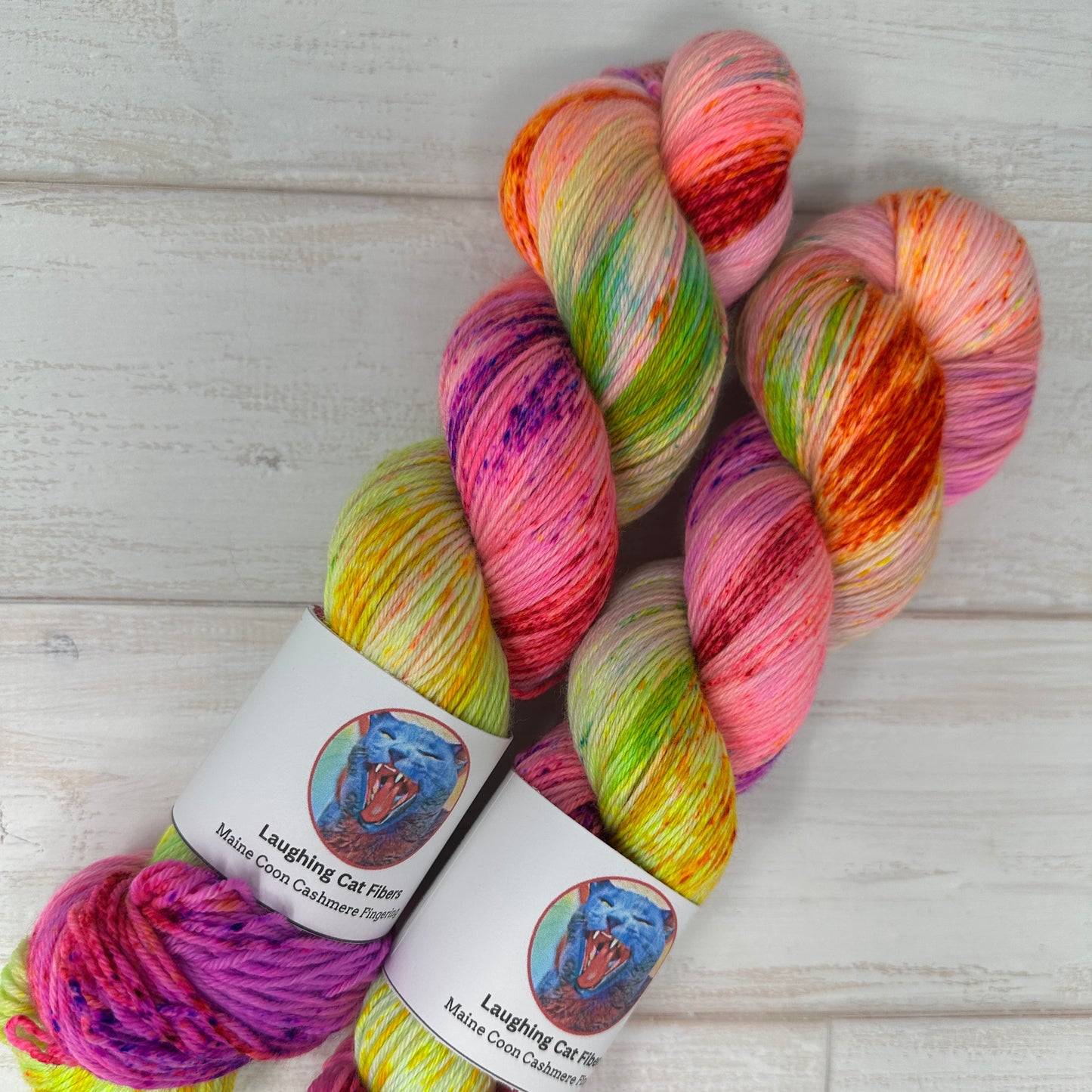 Multicolored skein of yarn with labels on a light wooden surface