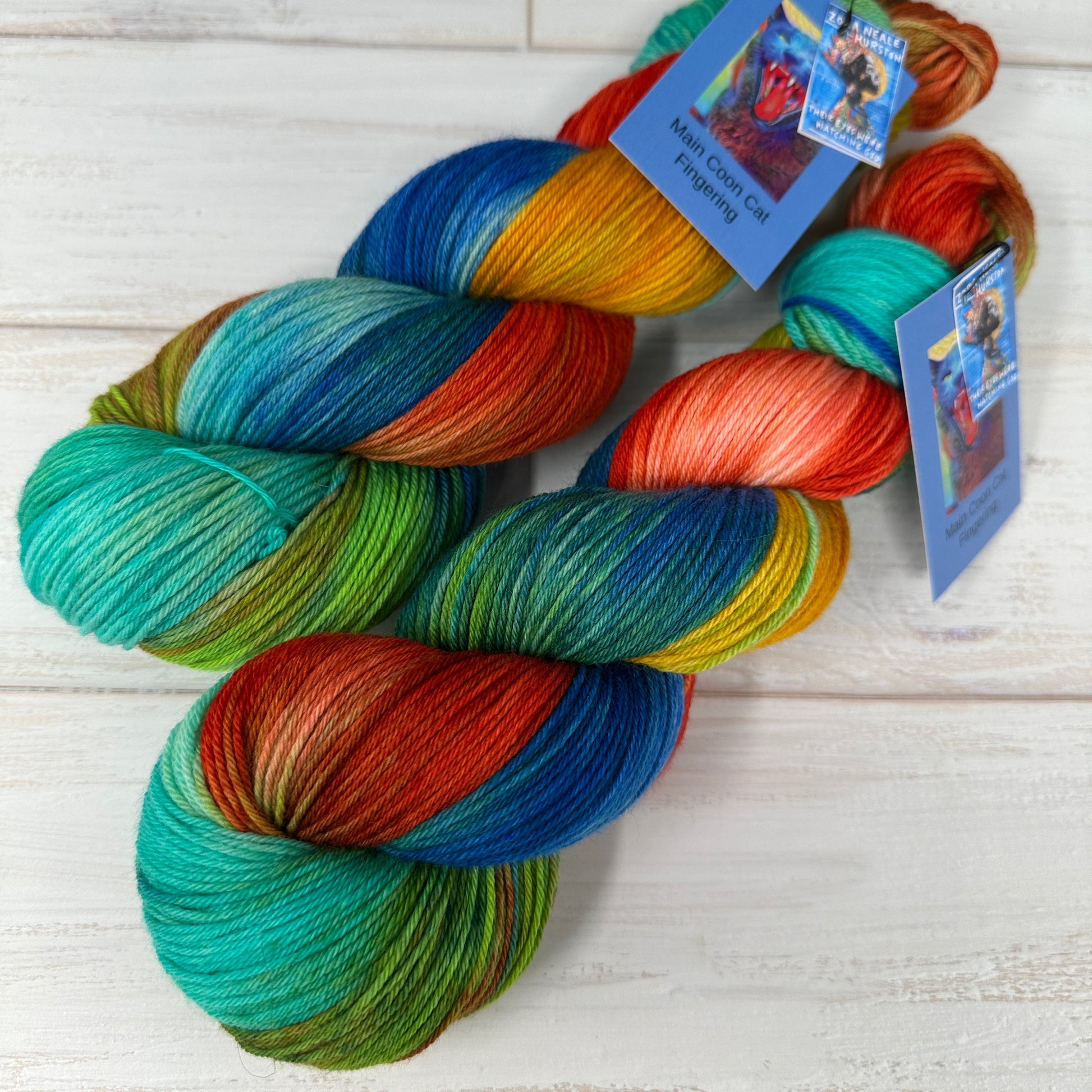 Colorful skeins of yarn with tags on a light wooden surface