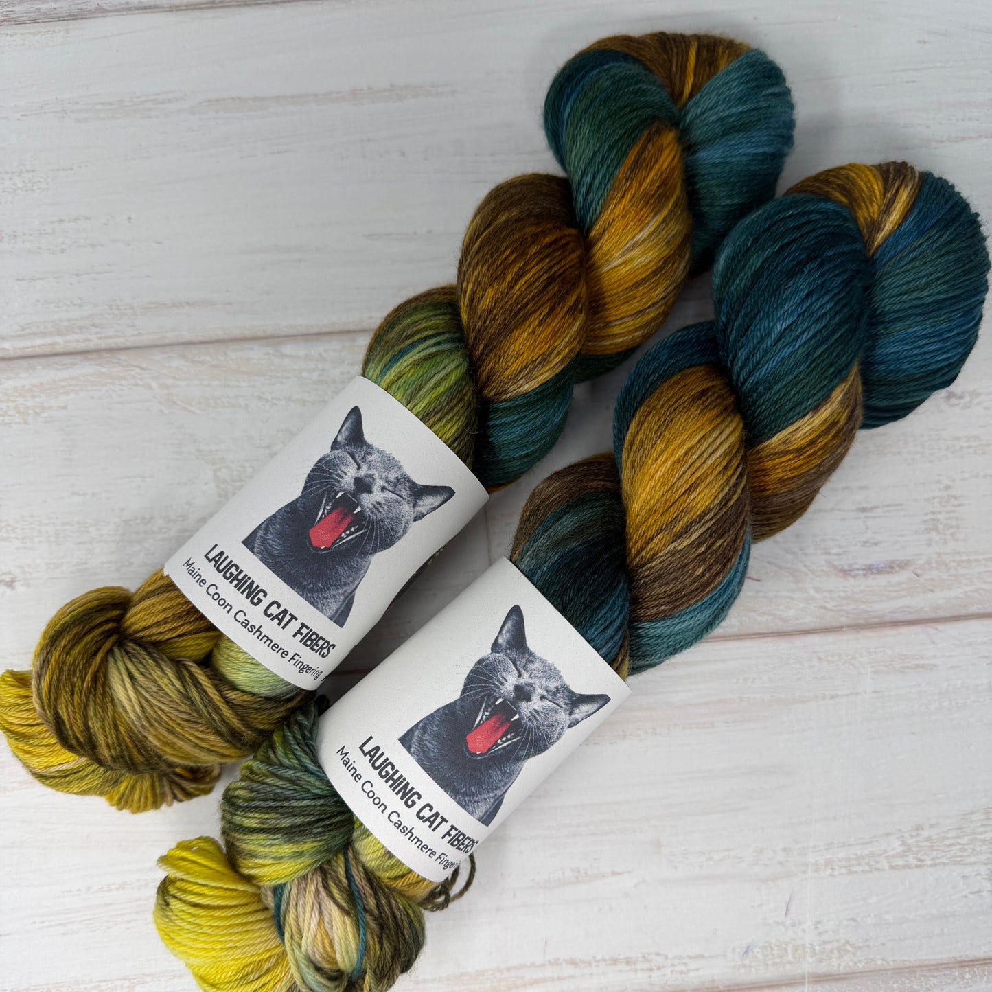 two skeins of MCN fingering hand dyed yarn by Laughing Cat Fibers in their Winter colorway 