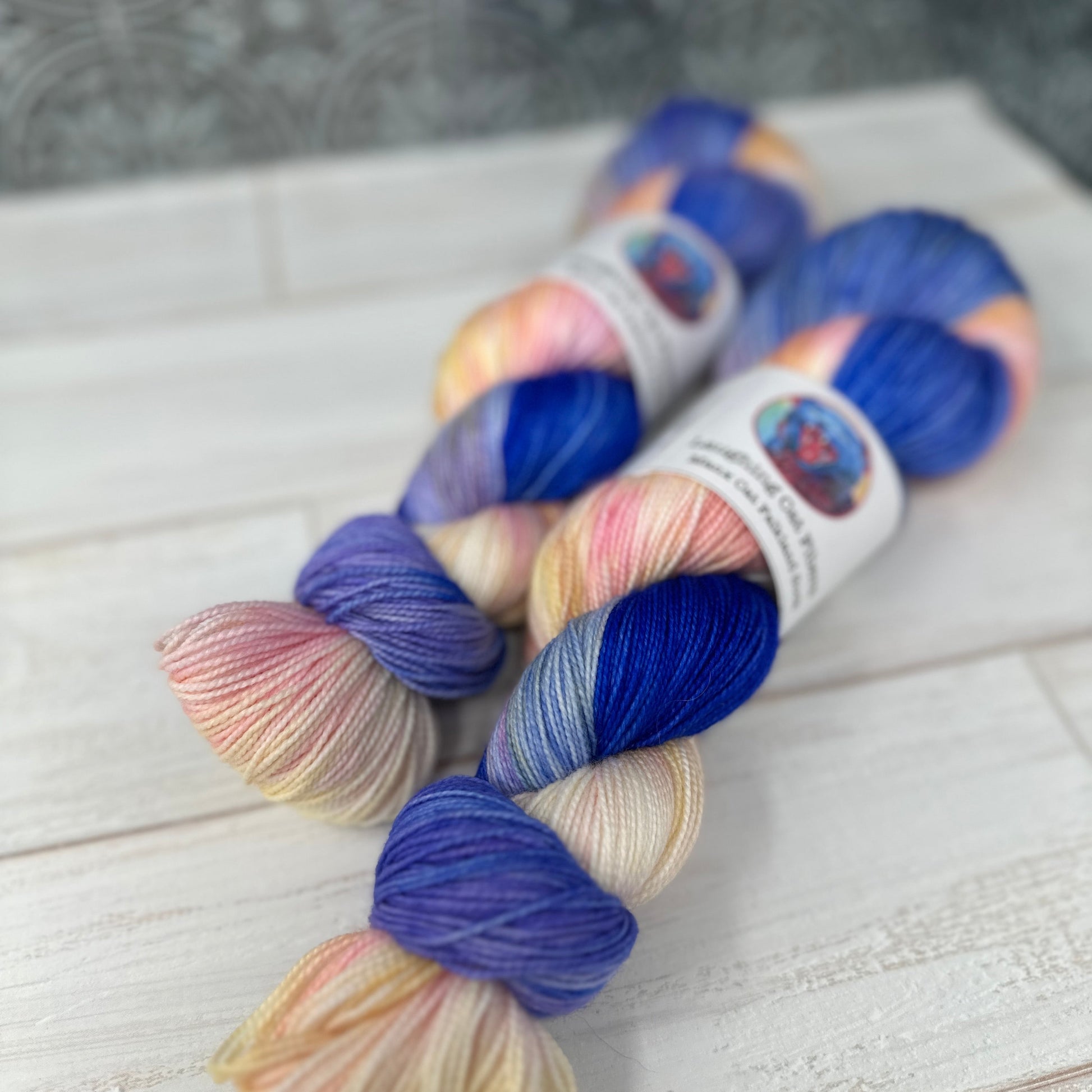 Multicolored yarn skeins on a textured surface