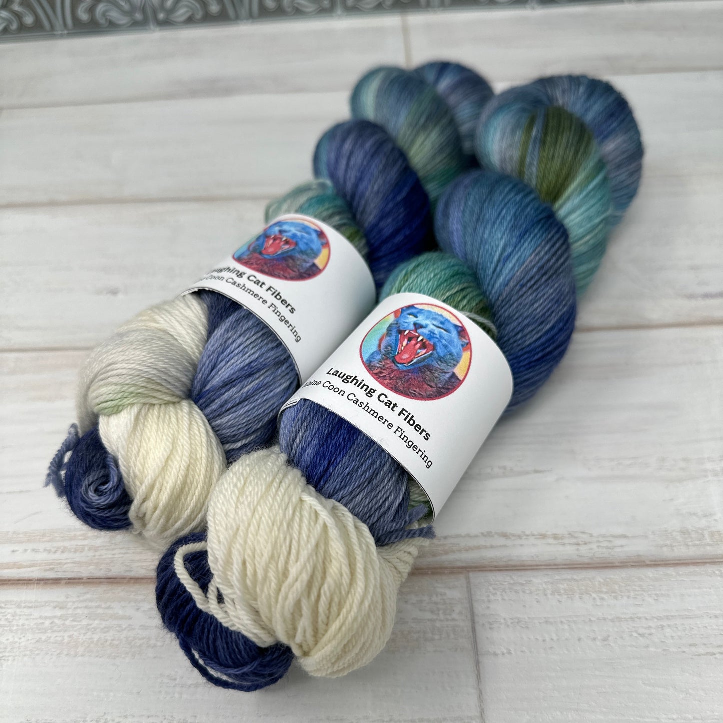 Close up of Maine Coon fingering yarn hand dyed by Laughing Cat Fibers is their Boreas colorway