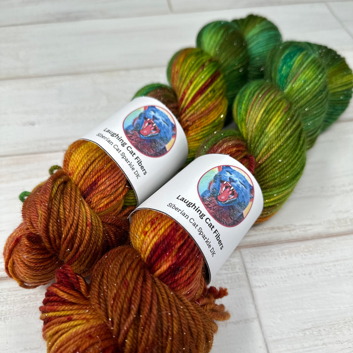 two skeins of sparkle dk yarn hand dyed by Laughing Cat Fibers in their Martha Mansfield colorway 