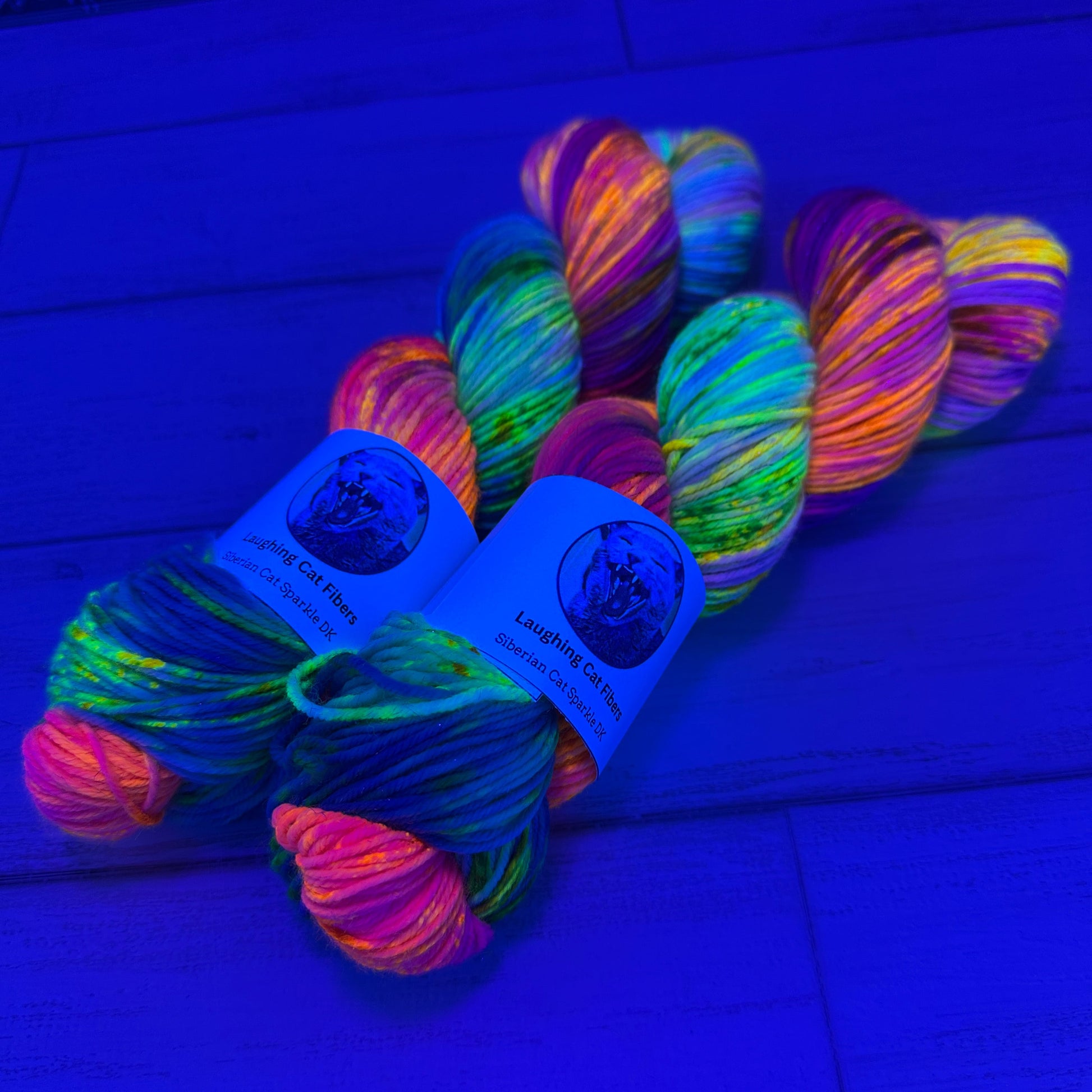 Neon multicolored yarn skein with labels on a blue background