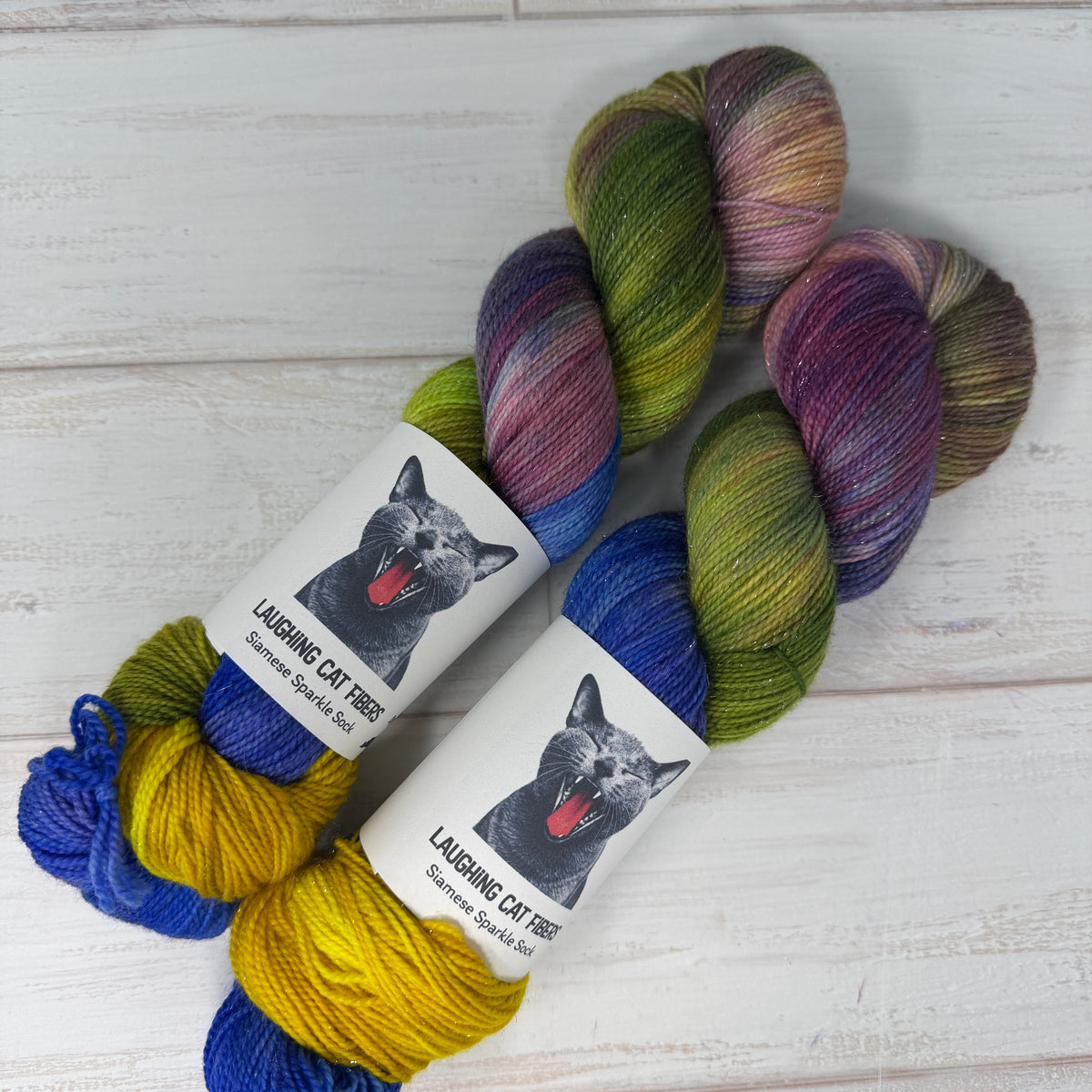 two skeins of Siamese Sparkle Sock yarn hand dyed by Laughing Cat Fibers in their Water Lilies 1916 colorway 