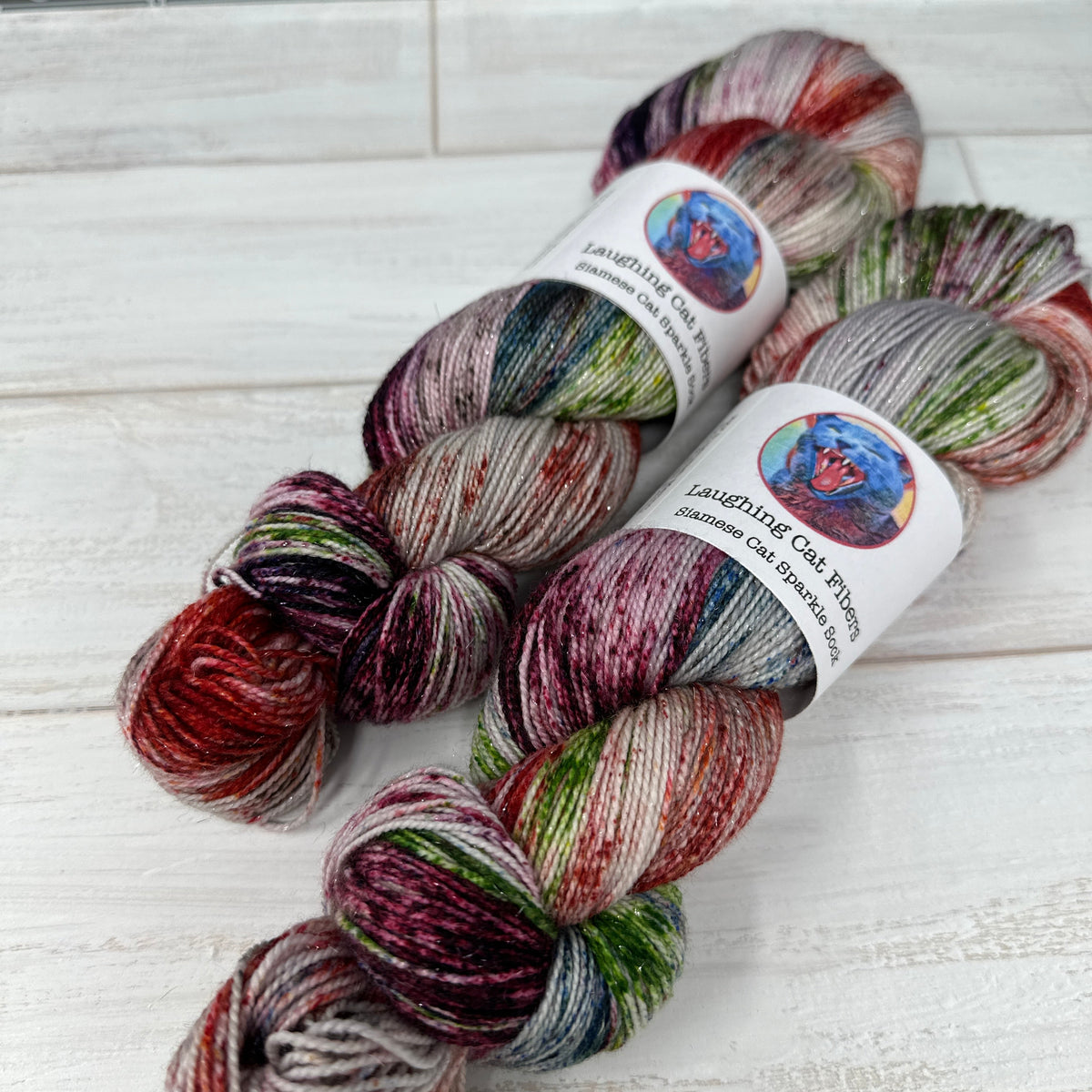 Multicolored skein of yarn with labels on a textured surface.