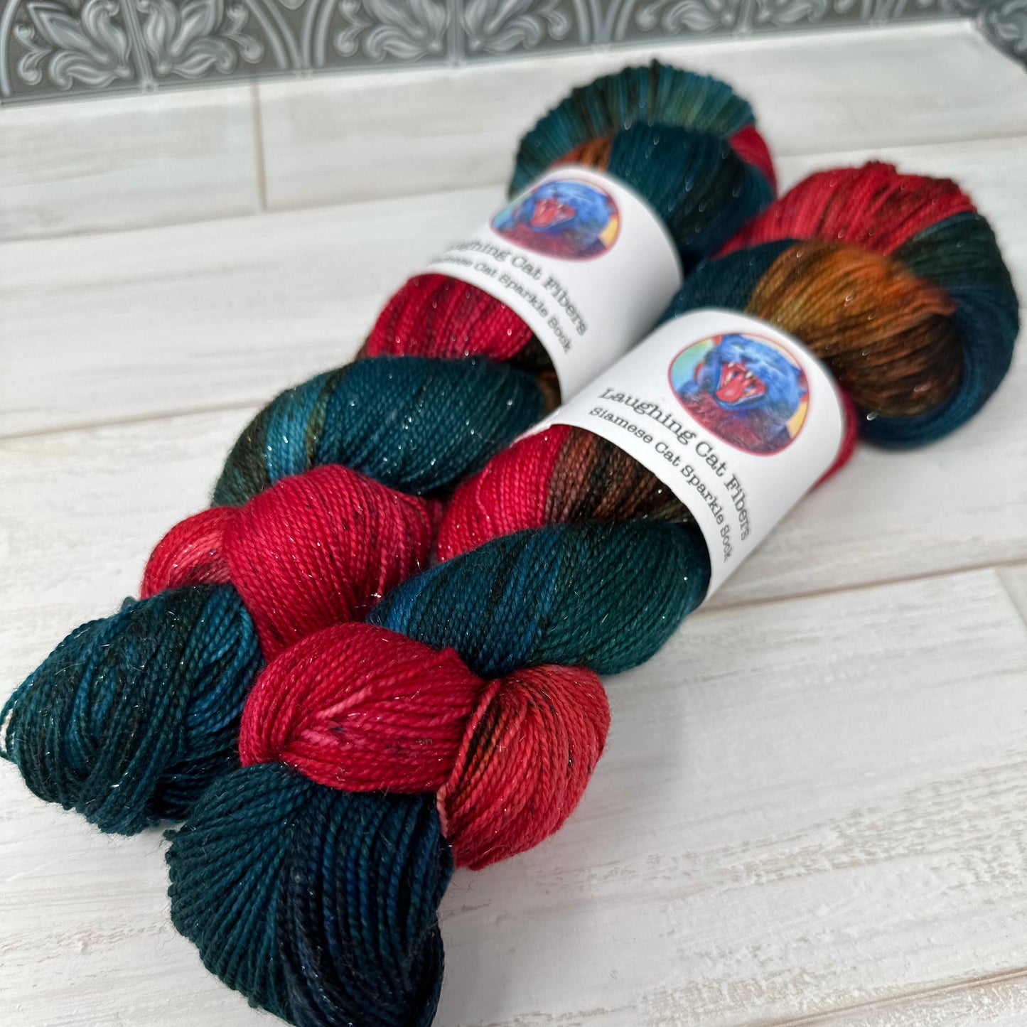 two skeins of hand dyed yarn by Laughing Cat Fibers in their Salmon Run colorway 