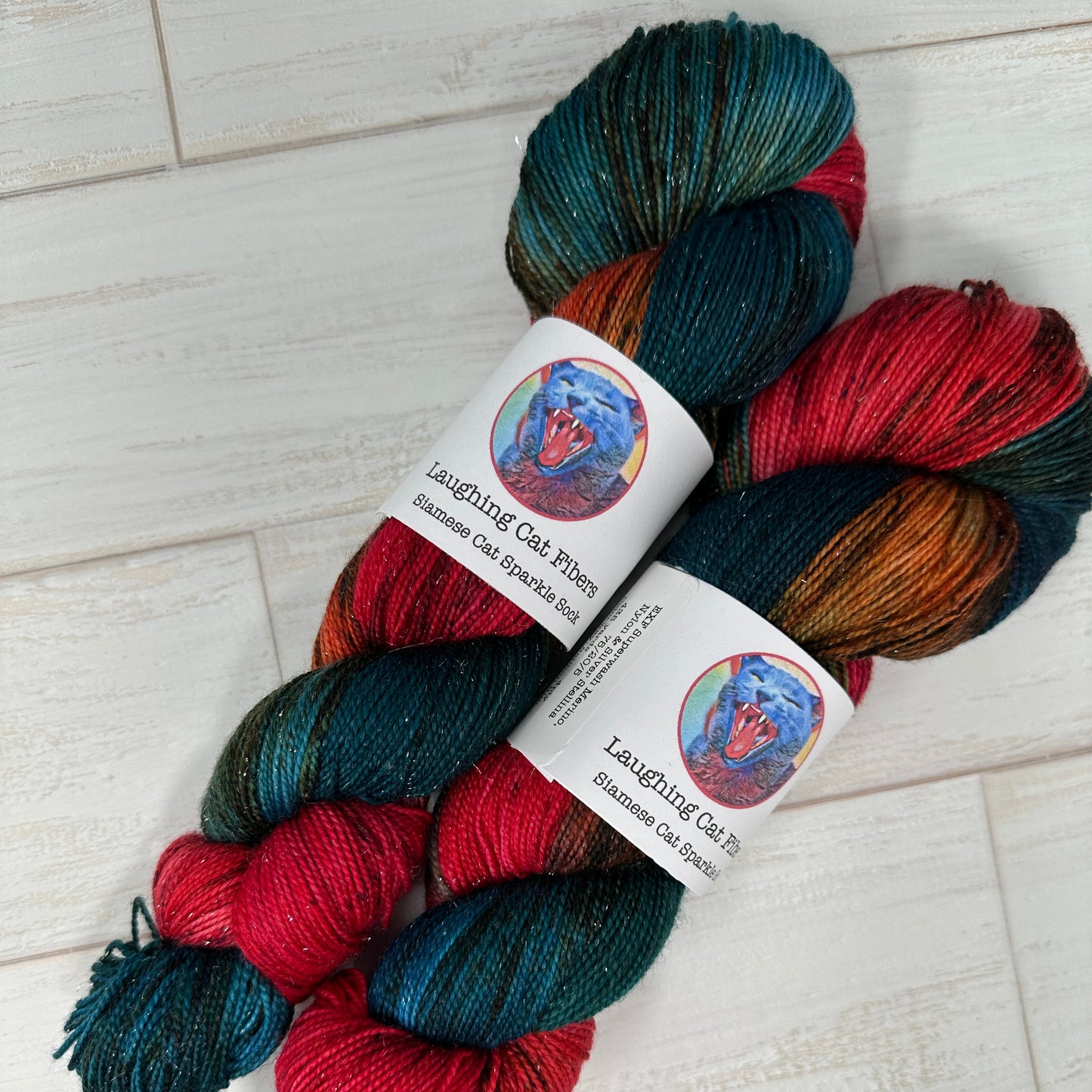 Multicolored skein of yarn with labels on a wooden surface