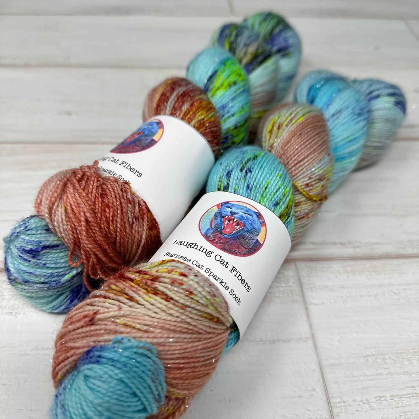 Colorful yarn skeins with labels on a textured surface