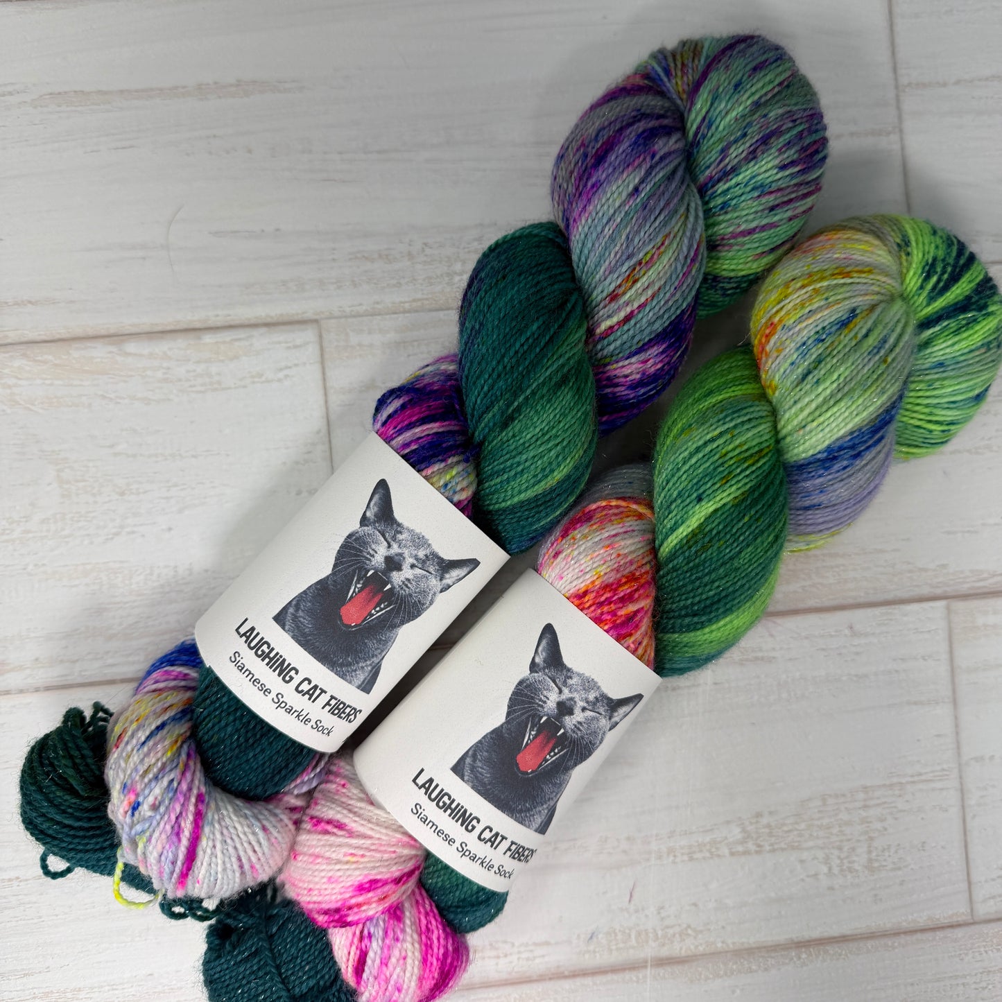 two skeins of sparkle sock yarn dyed by Laughing Cat Fibers in their Ophelia colorway 