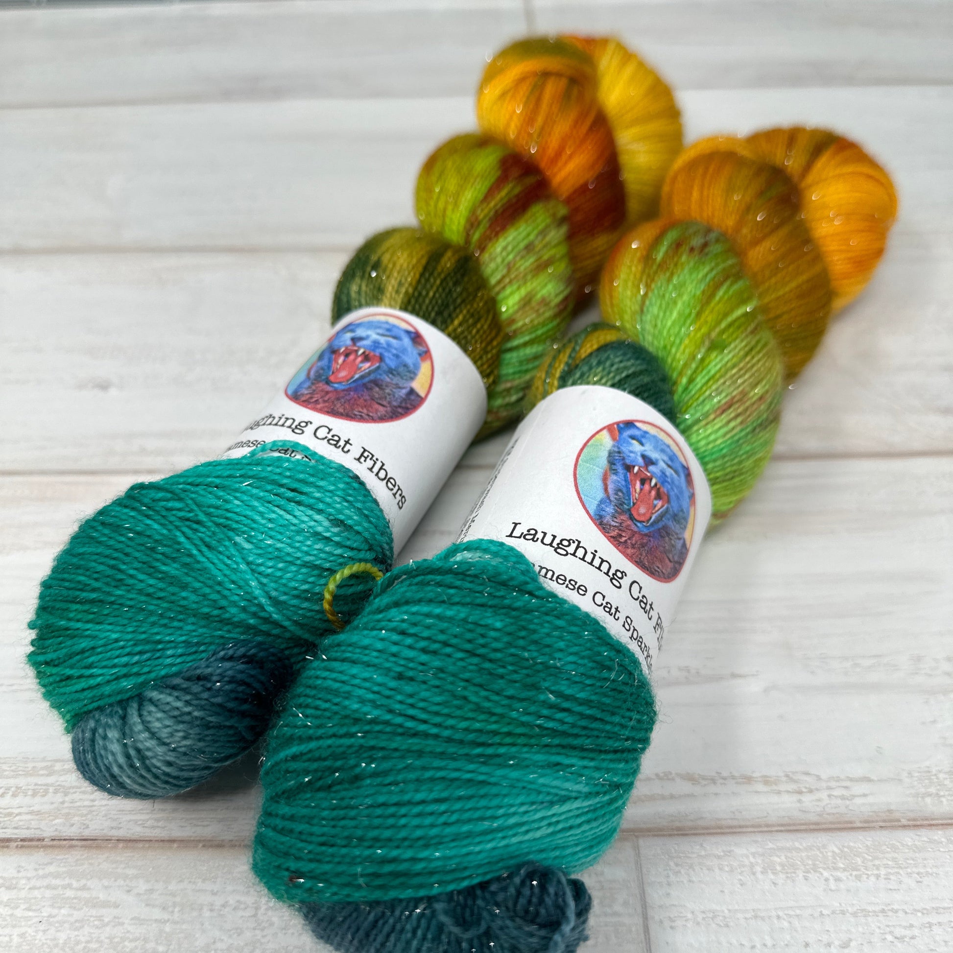 Colorful skeins of yarn hand dyed by Laughing Cat Fibers inspired by the banned book The Great Gatsby 