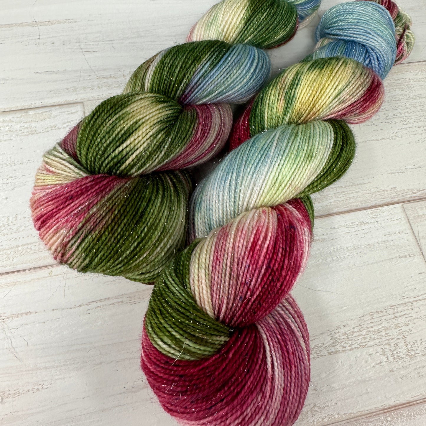 Multicolored skein of yarn on a light wooden surface