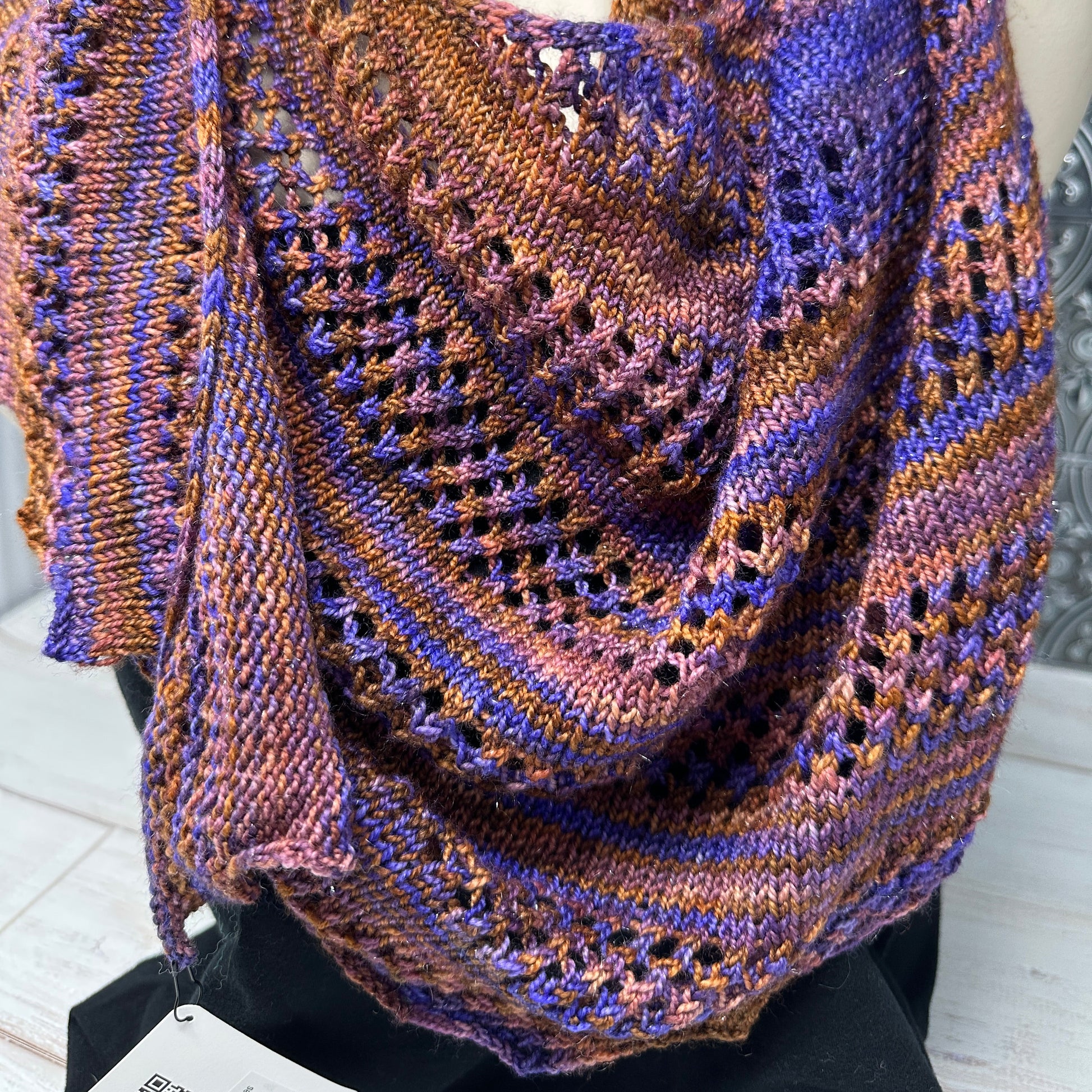 Knitted shawl with purple and brown yarn inspired by the banned book The Color Purple