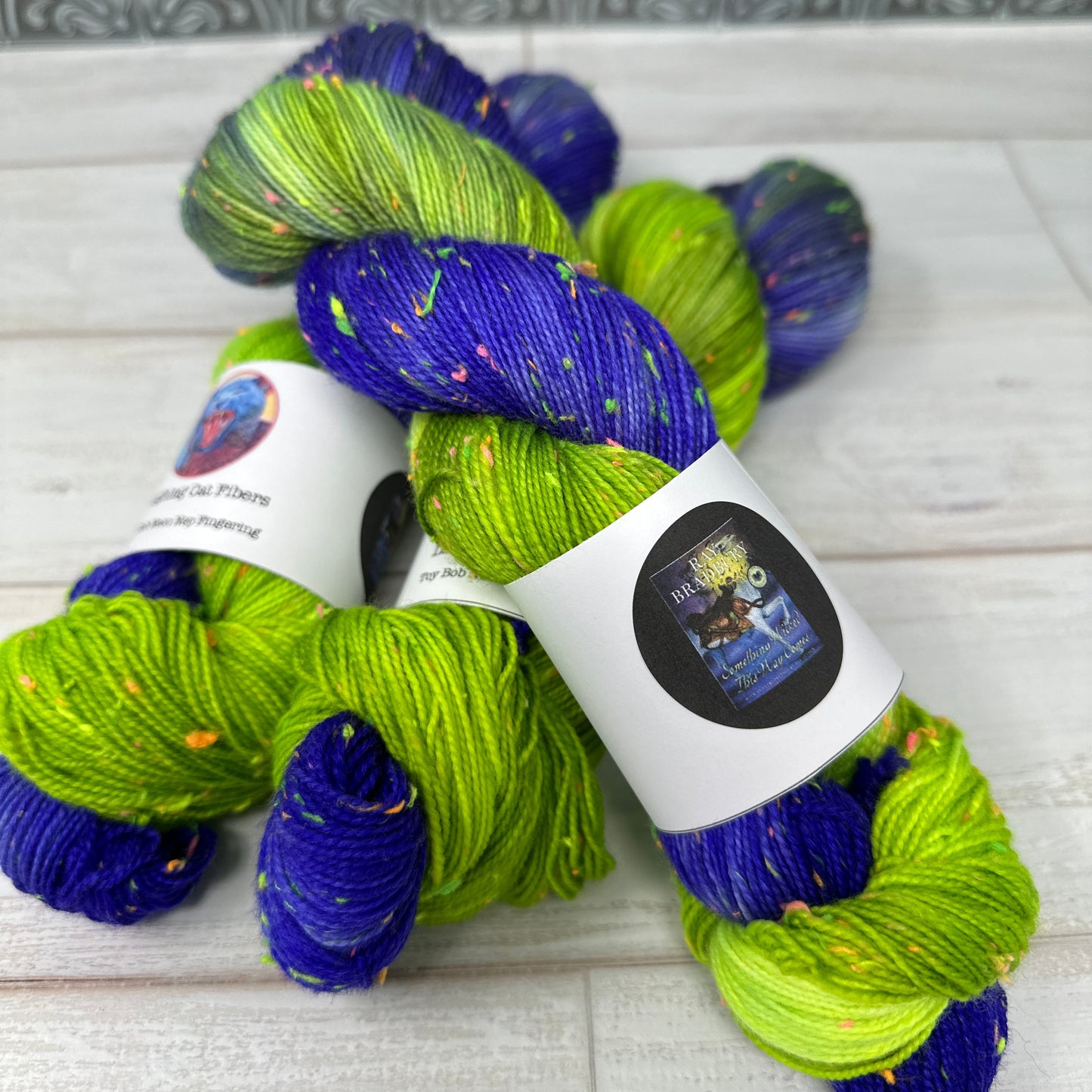 Blue and green yarn skein with labels on a textured surface