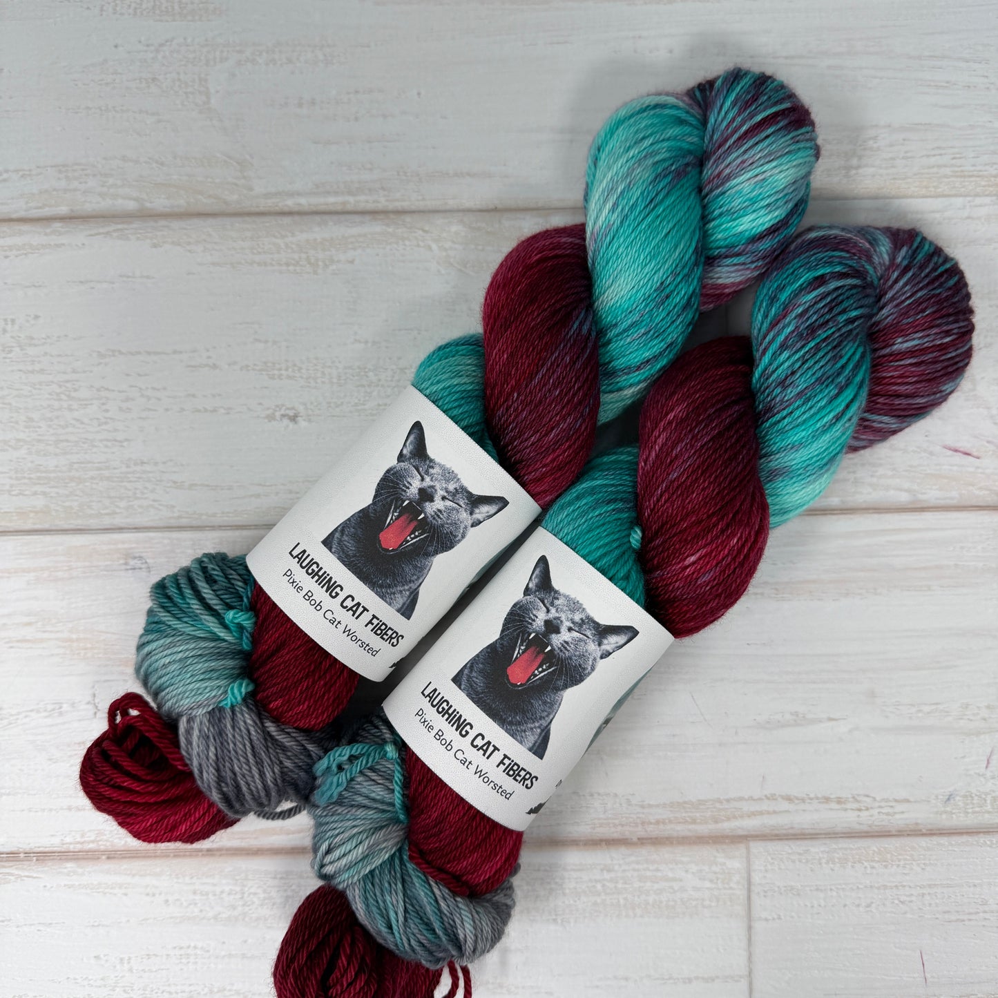 Multicolored yarn skeins with a label on a light wooden surface