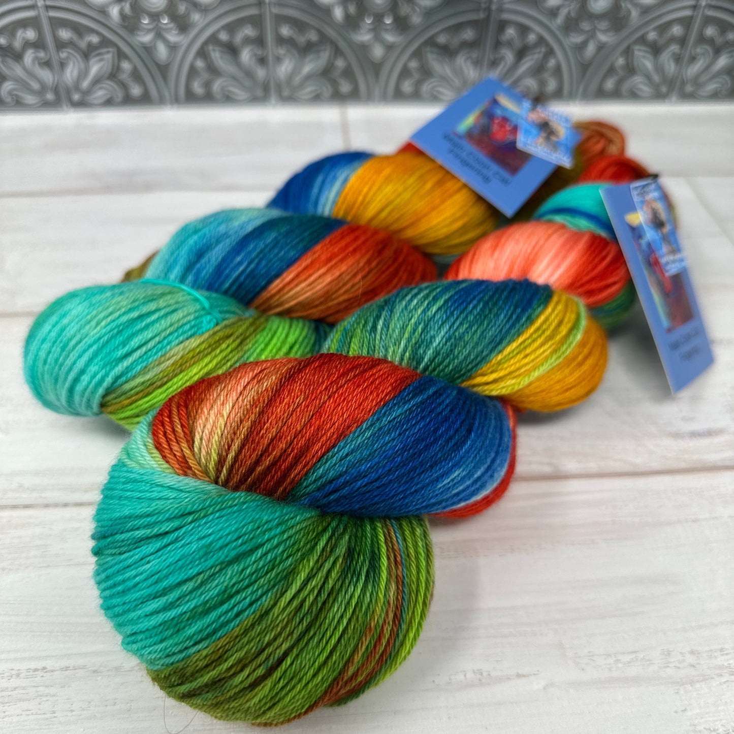 Multicolored skein of yarn with tags on a textured surface