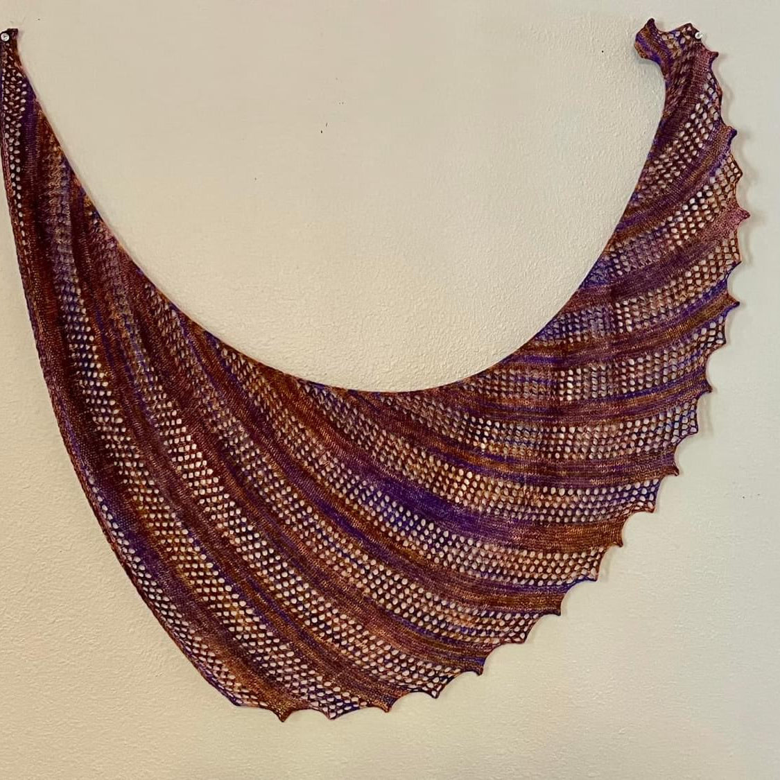 Knitted shawl with a wavy pattern on a beige background