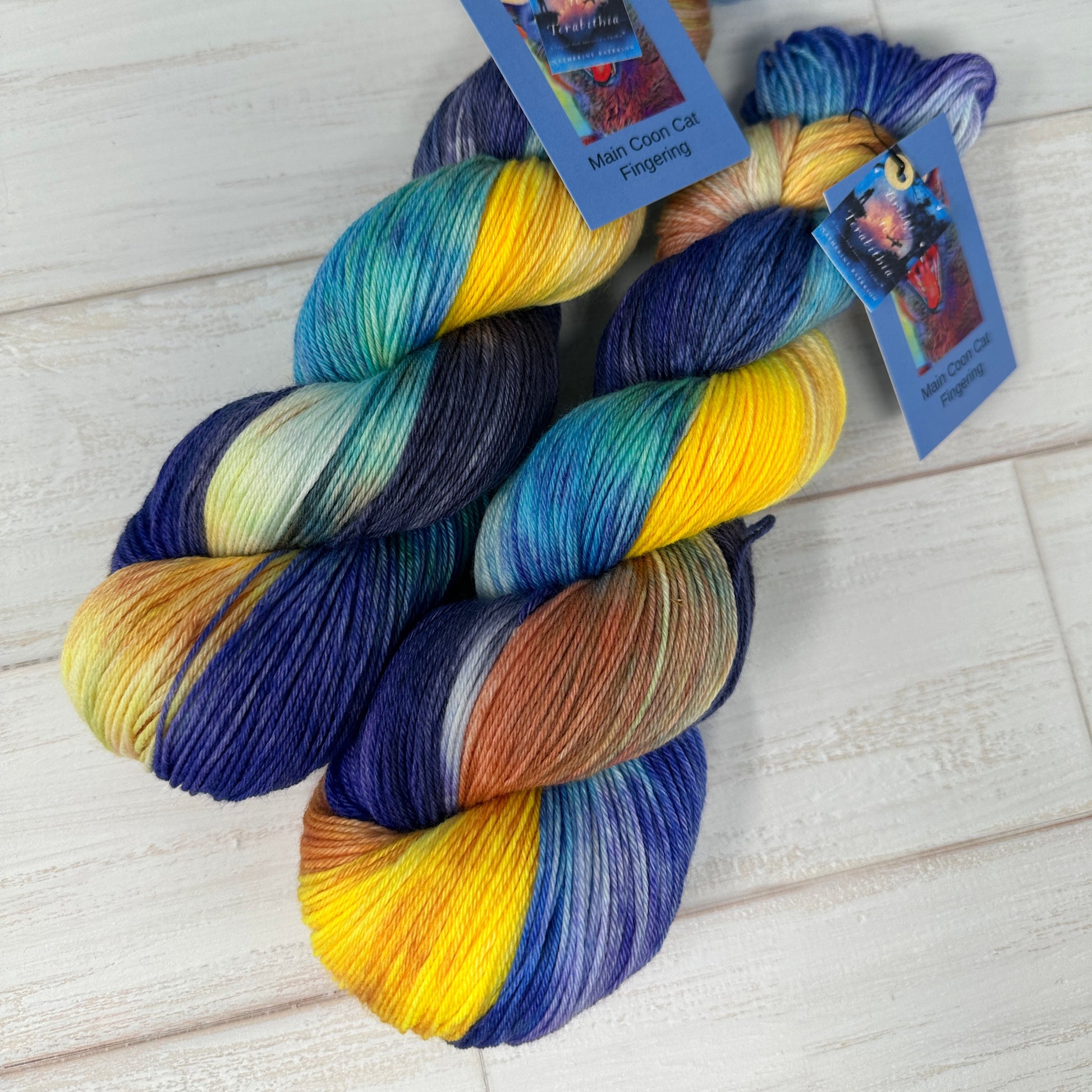 Multicolored yarn skeins with tags on a light wooden surface