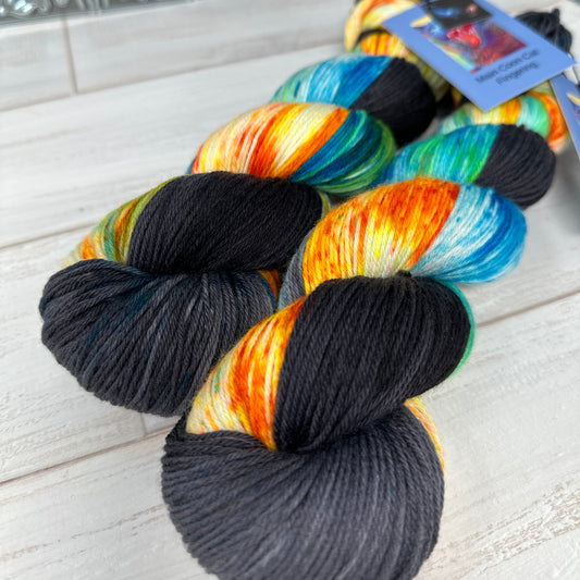 two skeins of MCN fingering hand dyed yarn by laughing cat fibers dyed in their Hand of God colorway