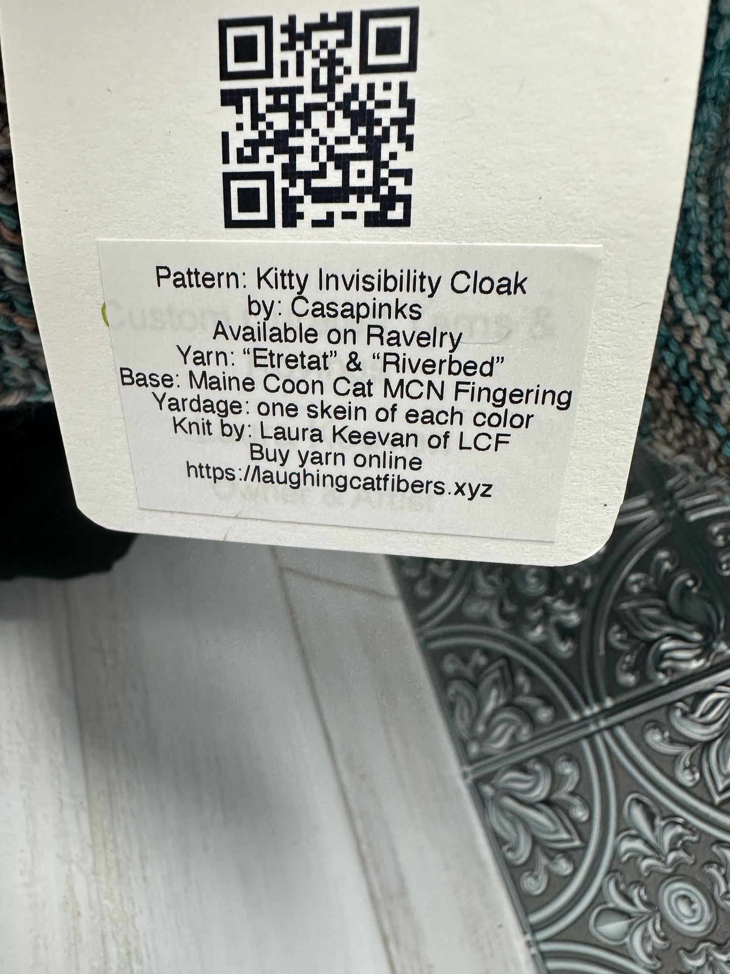 Label with text and QR code on a fabric background