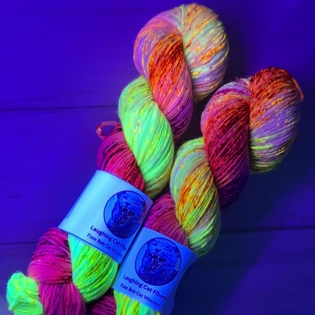 video clip of hand dyed yarn under black light by Laughing Cat Fibers in their Opalite colorway 
