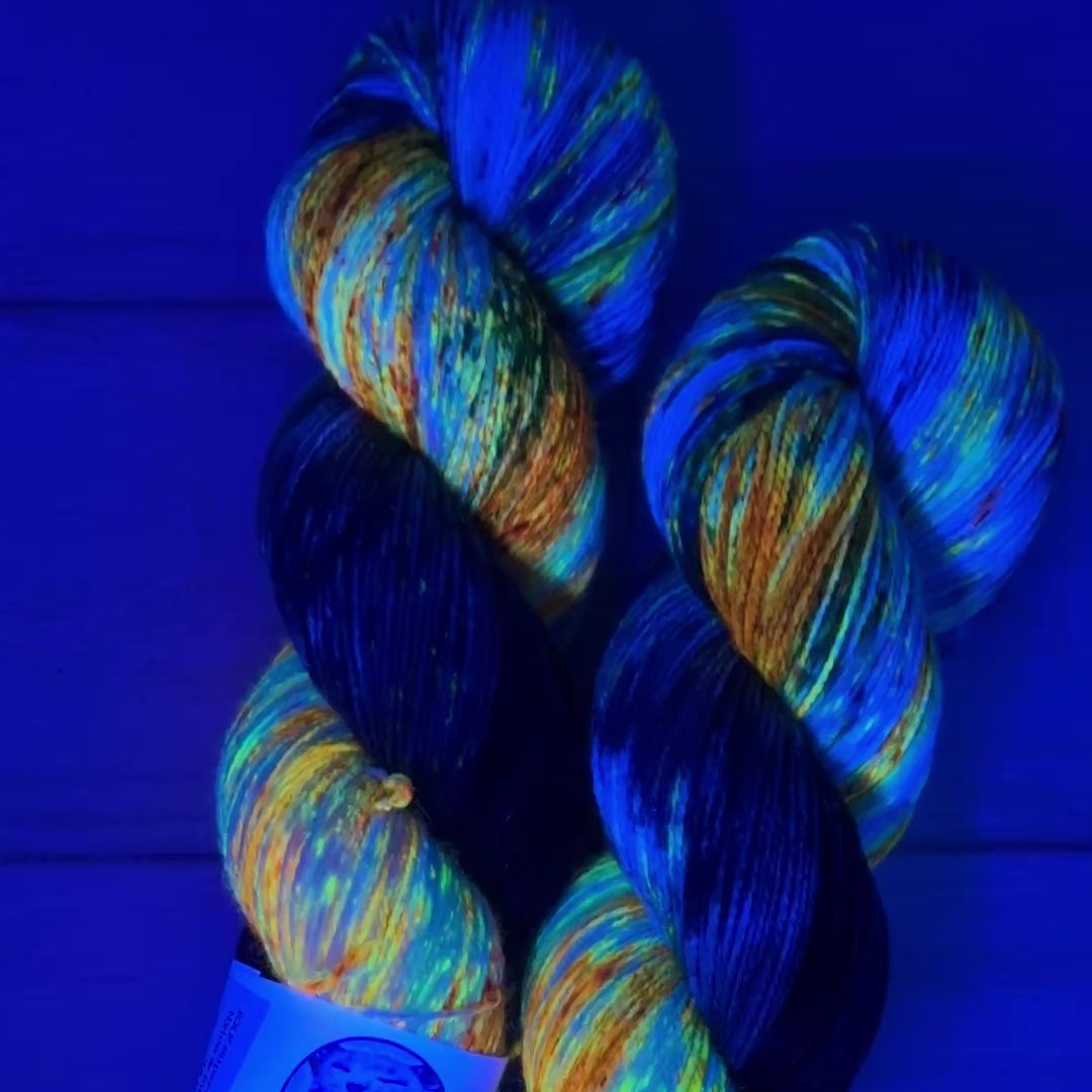 video clip of hand dyed yarn by Laughing Cat Fibers under black light 