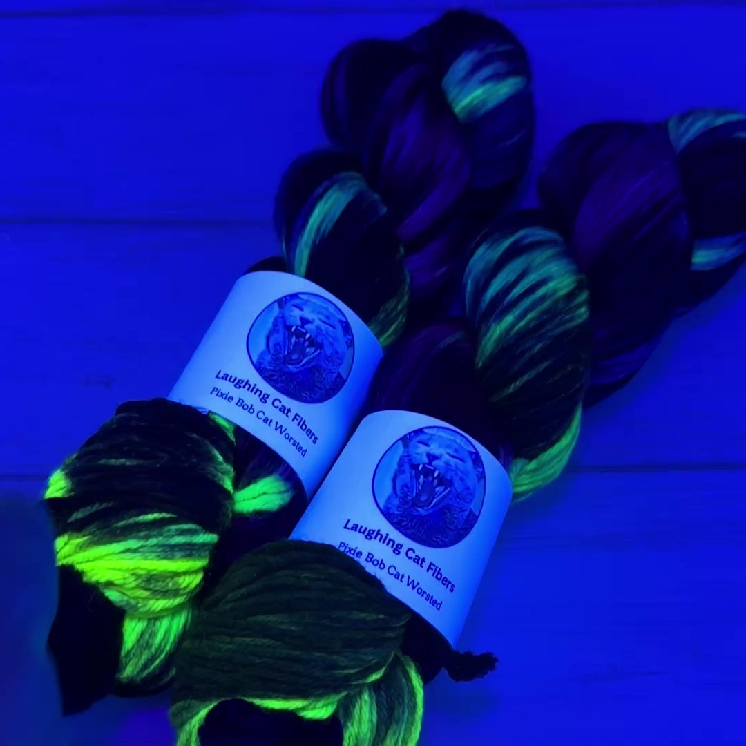 video clip of yarn under a black light