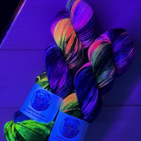 Video Clip of Cartwheel Galaxy yarn under black light by Laughing Cat Fibers 