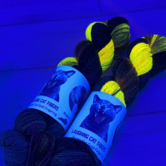 UV video clip of Laughing Cat Fibers yarn in the Goldfish colorway 