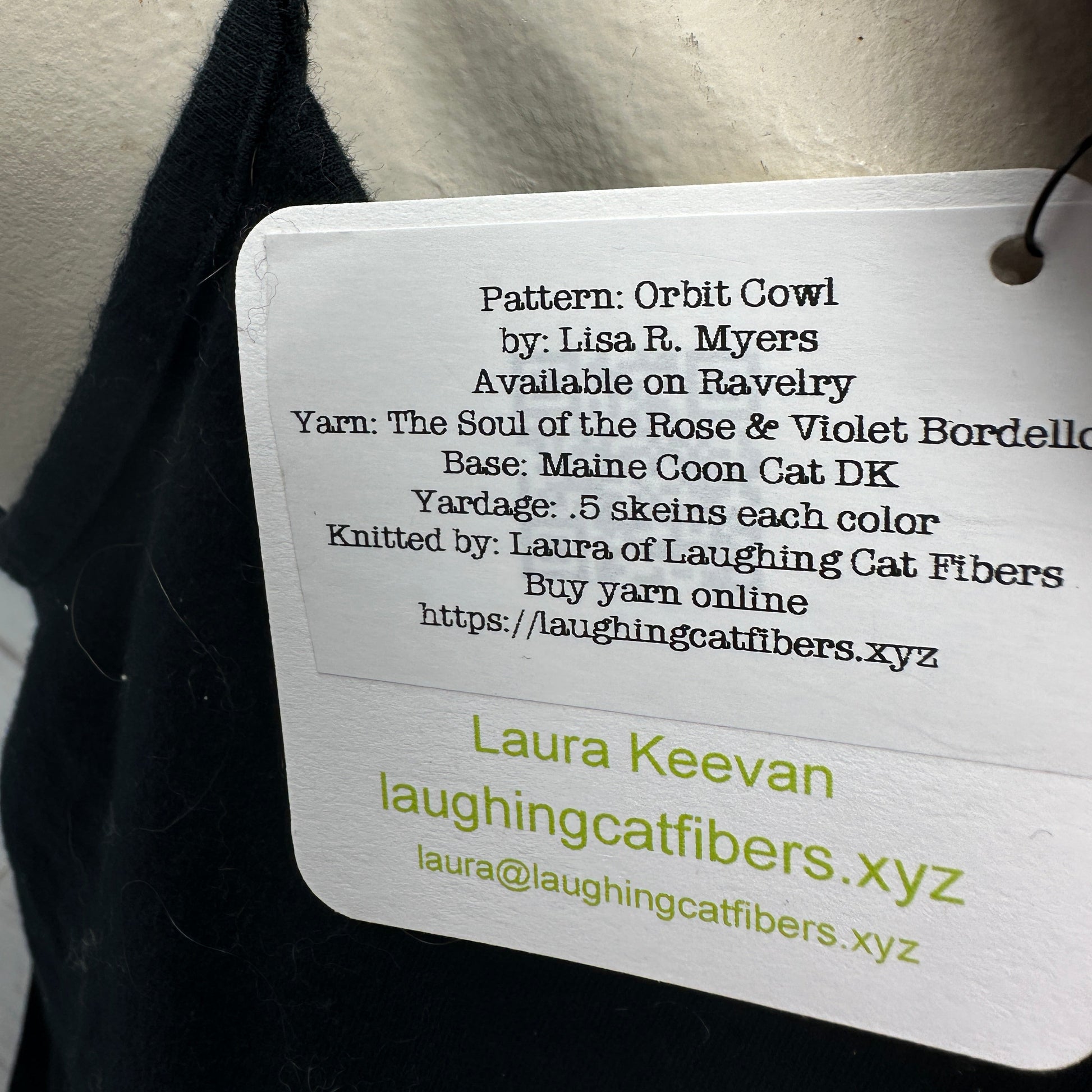 Tag with knitting pattern information on a textured fabric background