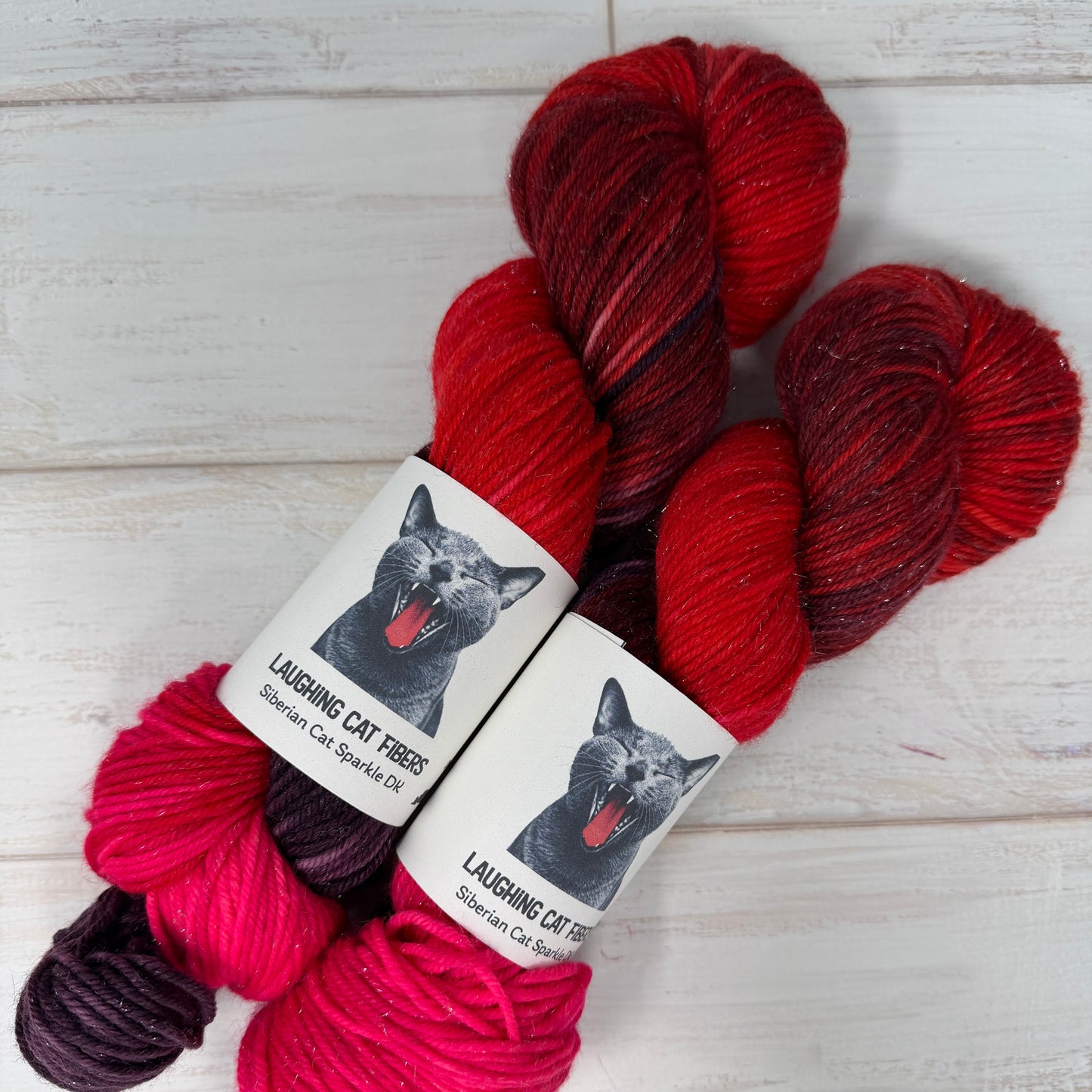 Red and purple sparkle DK yarn hand dyed by Laughing Cat Fibers in their Heart Nebula colorway 