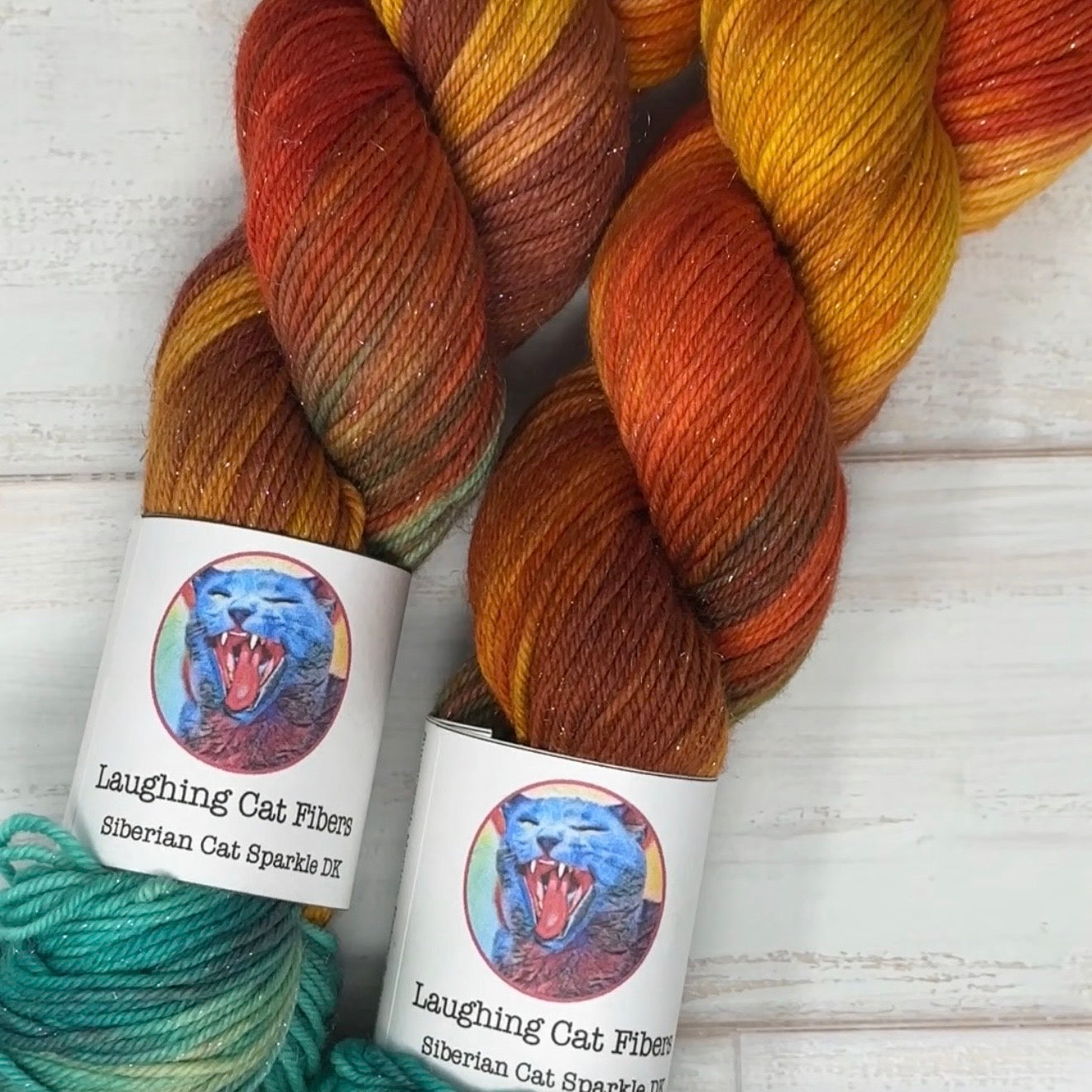 two skeins of sparkle DK yarn hand dyed by Laughing Cat Fibers in their Vincent's Sunflowers colorway