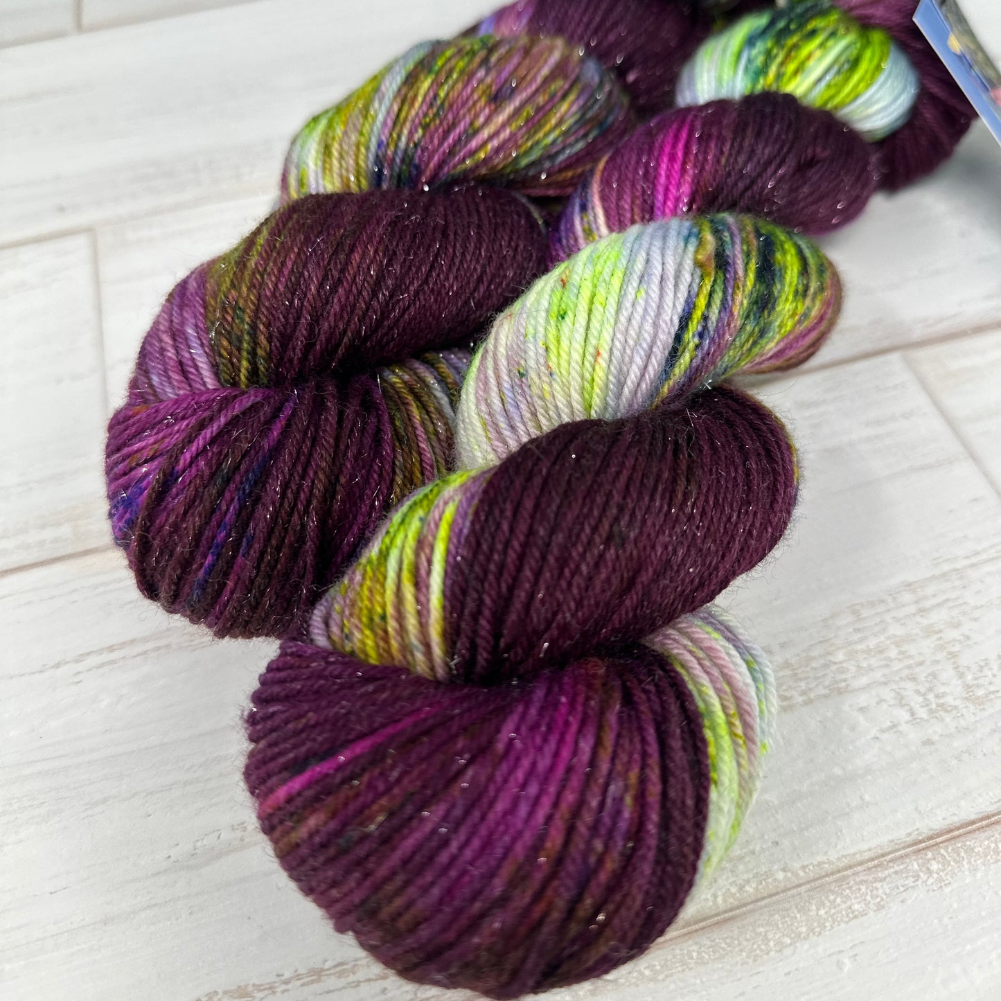 two skeins of hand dyed yarn by Laughing Cat Fibers in their Weeping Willow colorway