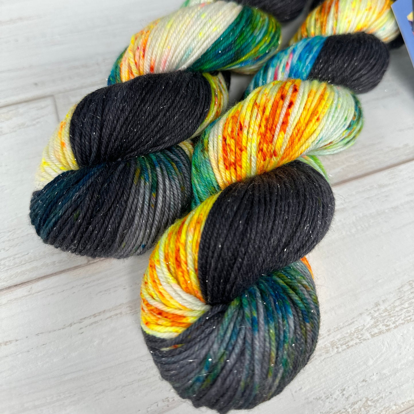 two skeins of hand dyed yarn by Laughing Cat Fibers in their Hand of God colorway 