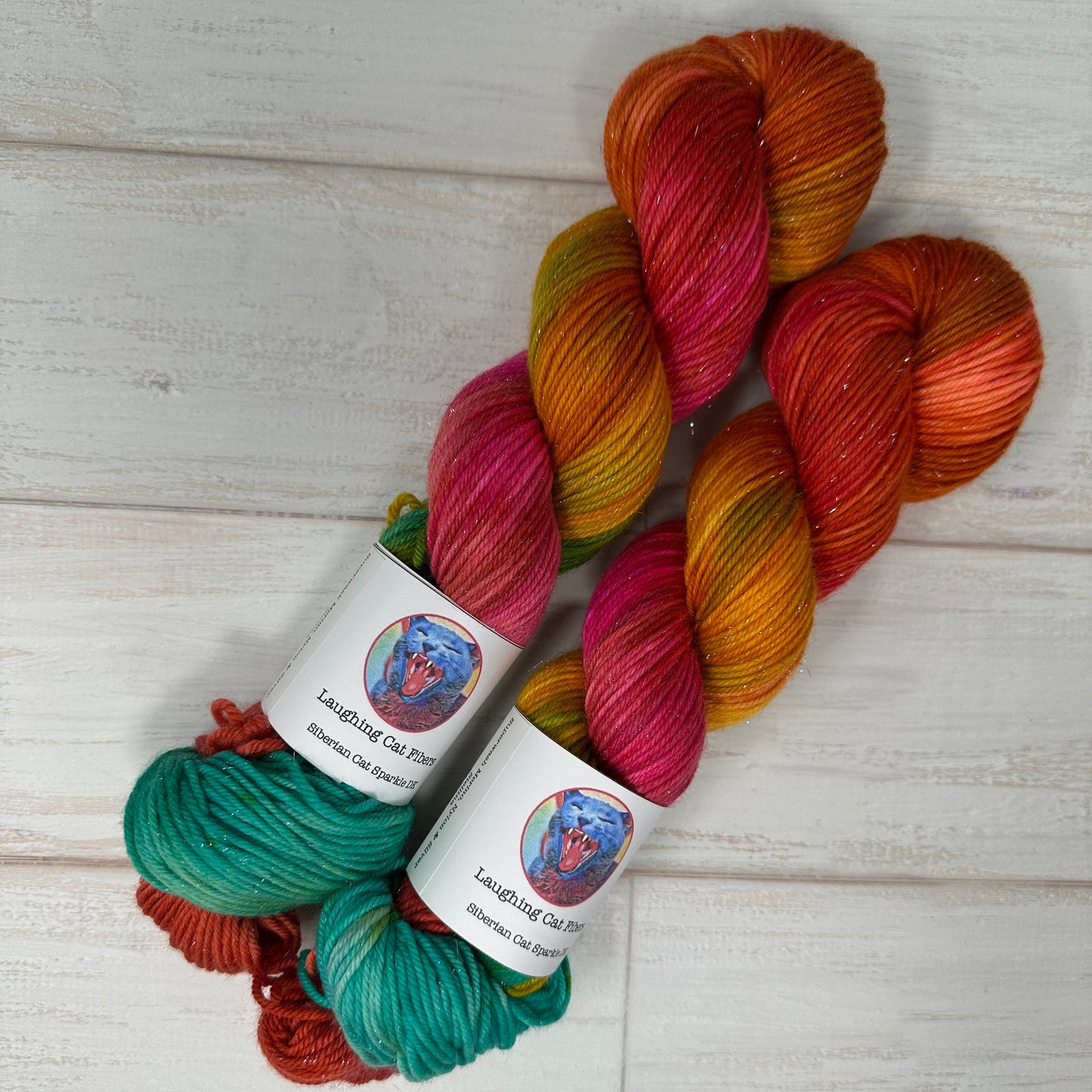 Colorful skeins of yarn with labels on a light wooden surface